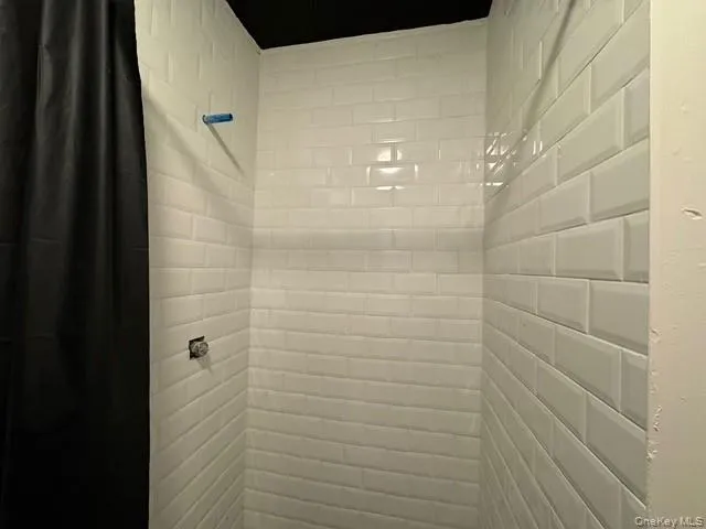 Bathroom view of ceramic tiled shower. Bathroom view of ceramic tiled shower.