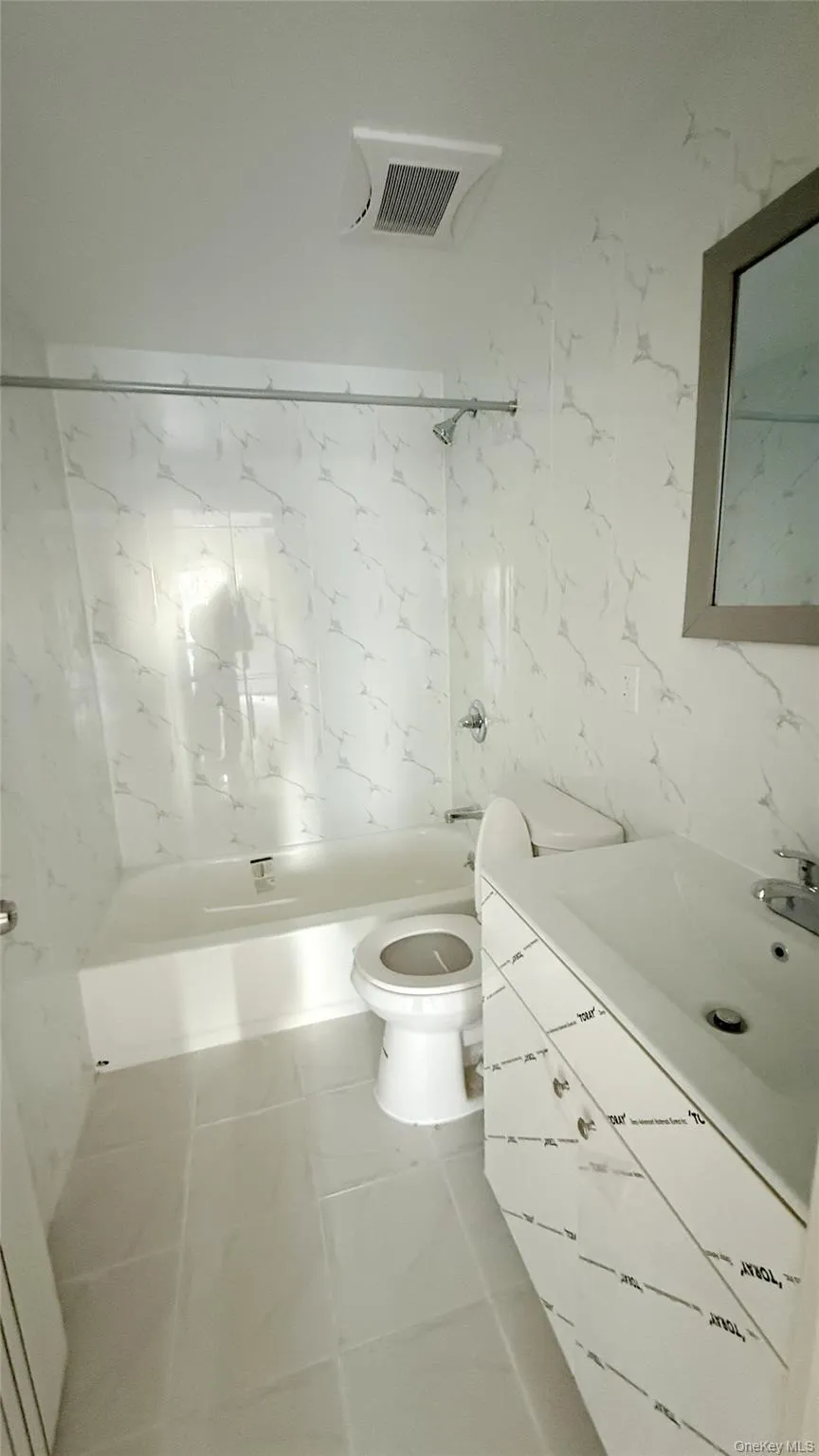 Full bath featuring vanity and shower / washtub combination Full bath featuring vanity and shower / washtub combination