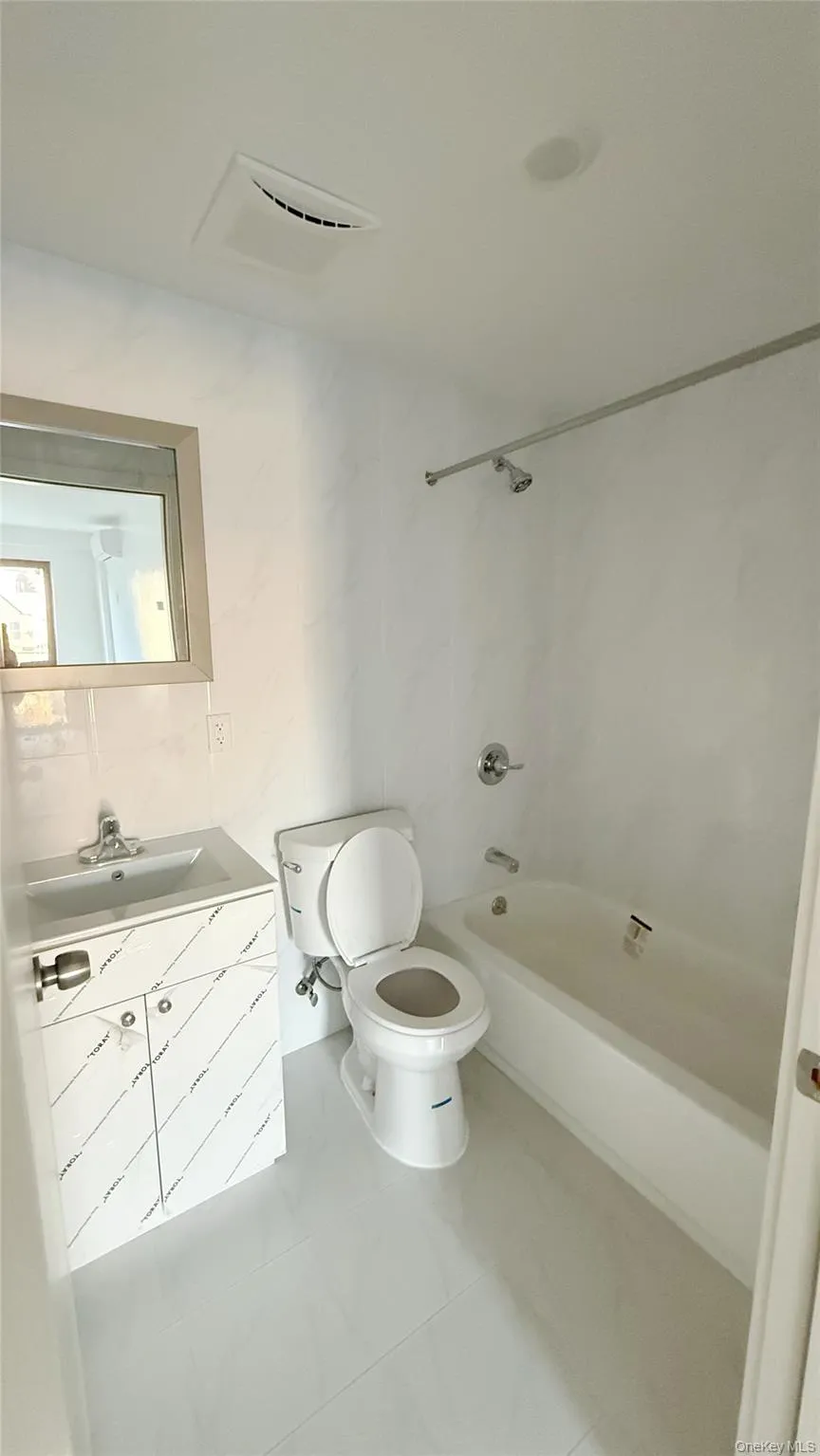 Full bathroom featuring vanity and shower / tub combination Full bathroom featuring vanity and shower / tub combination