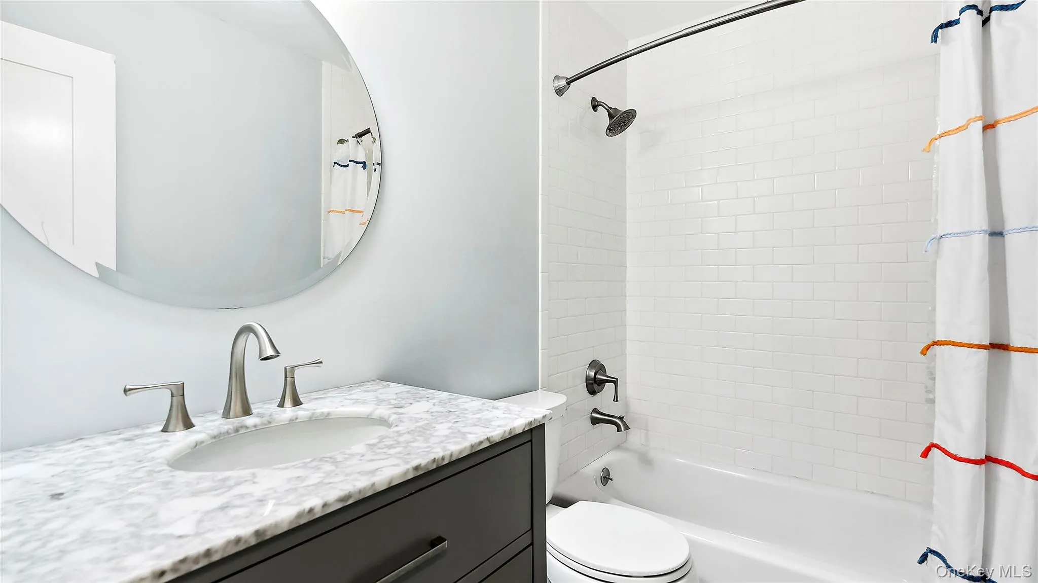 Bathroom featuring shower / bath combination with curtain and vanity Bathroom featuring shower / bath combination with curtain and vanity