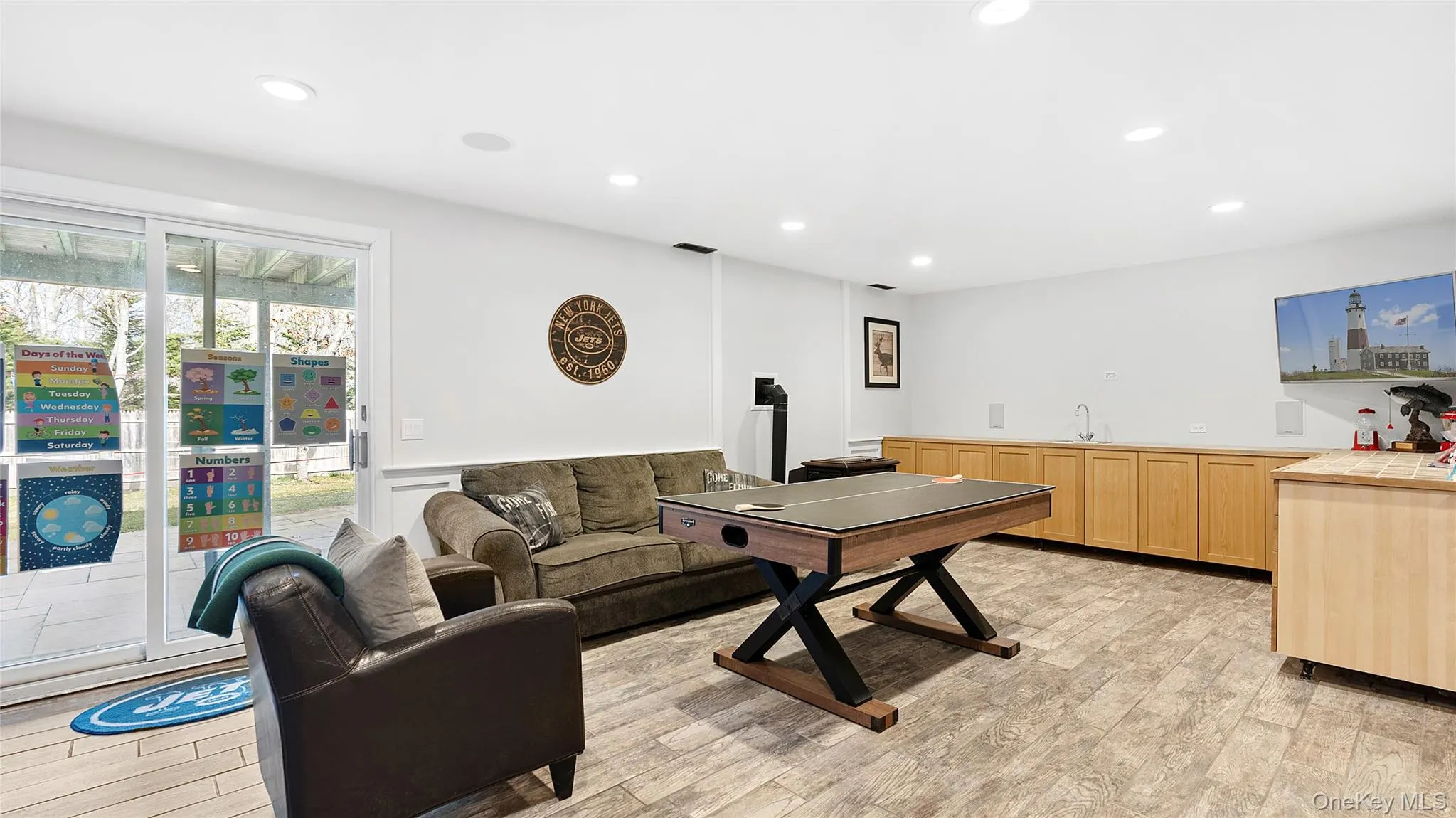 Living room with recessed lighting and light wood-style floors Living room with recessed lighting and light wood-style floors