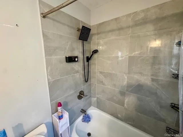 Full bath with shower / bathtub combination and toilet Full bath with shower / bathtub combination and toilet