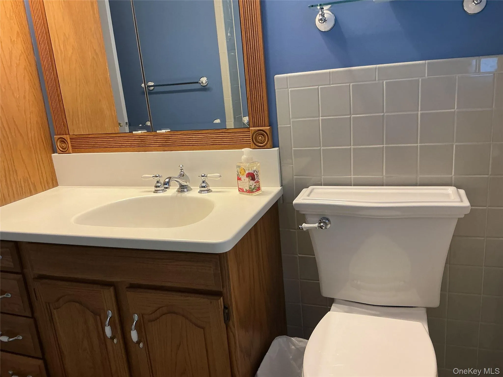 Bathroom featuring vanity and tile walls Bathroom featuring vanity and tile walls
