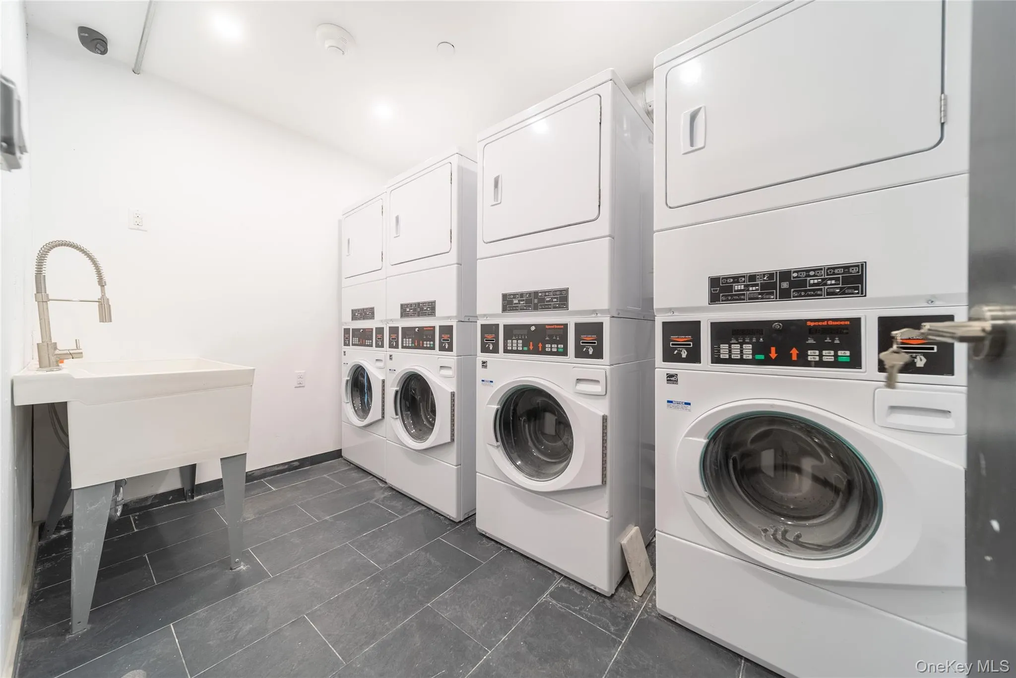 Shared laundry room featuring estacked washer and dryer Shared laundry room featuring estacked washer and dryer