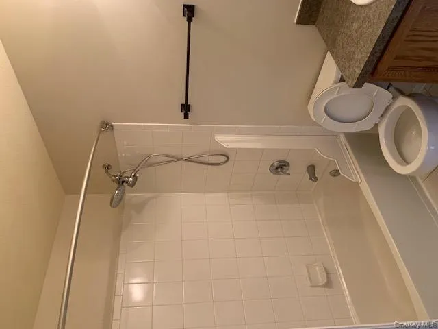 Full bath featuring vanity and shower combination Full bath featuring vanity and shower combination