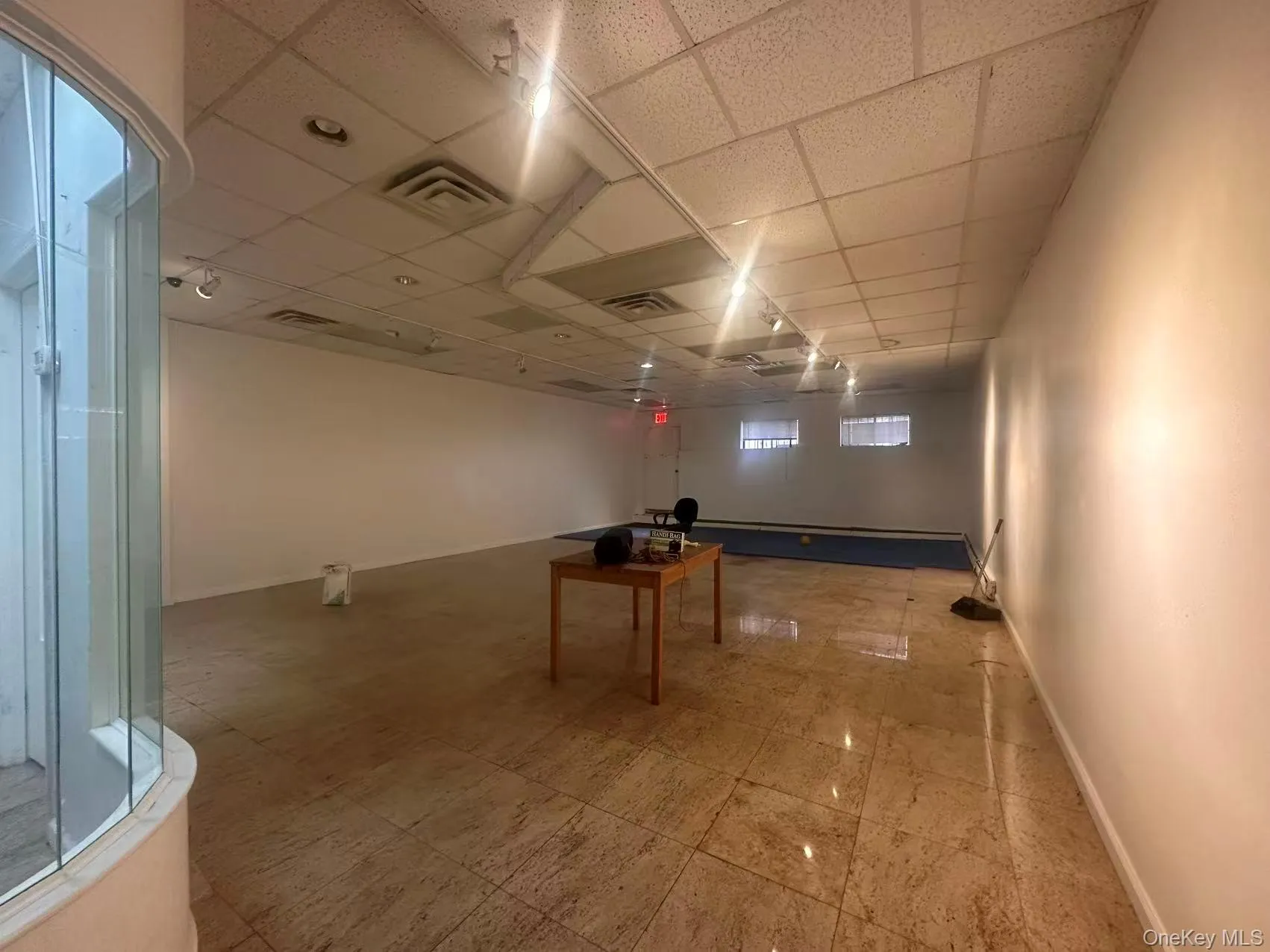 Basement featuring baseboards and a drop ceiling Basement featuring baseboards and a drop ceiling