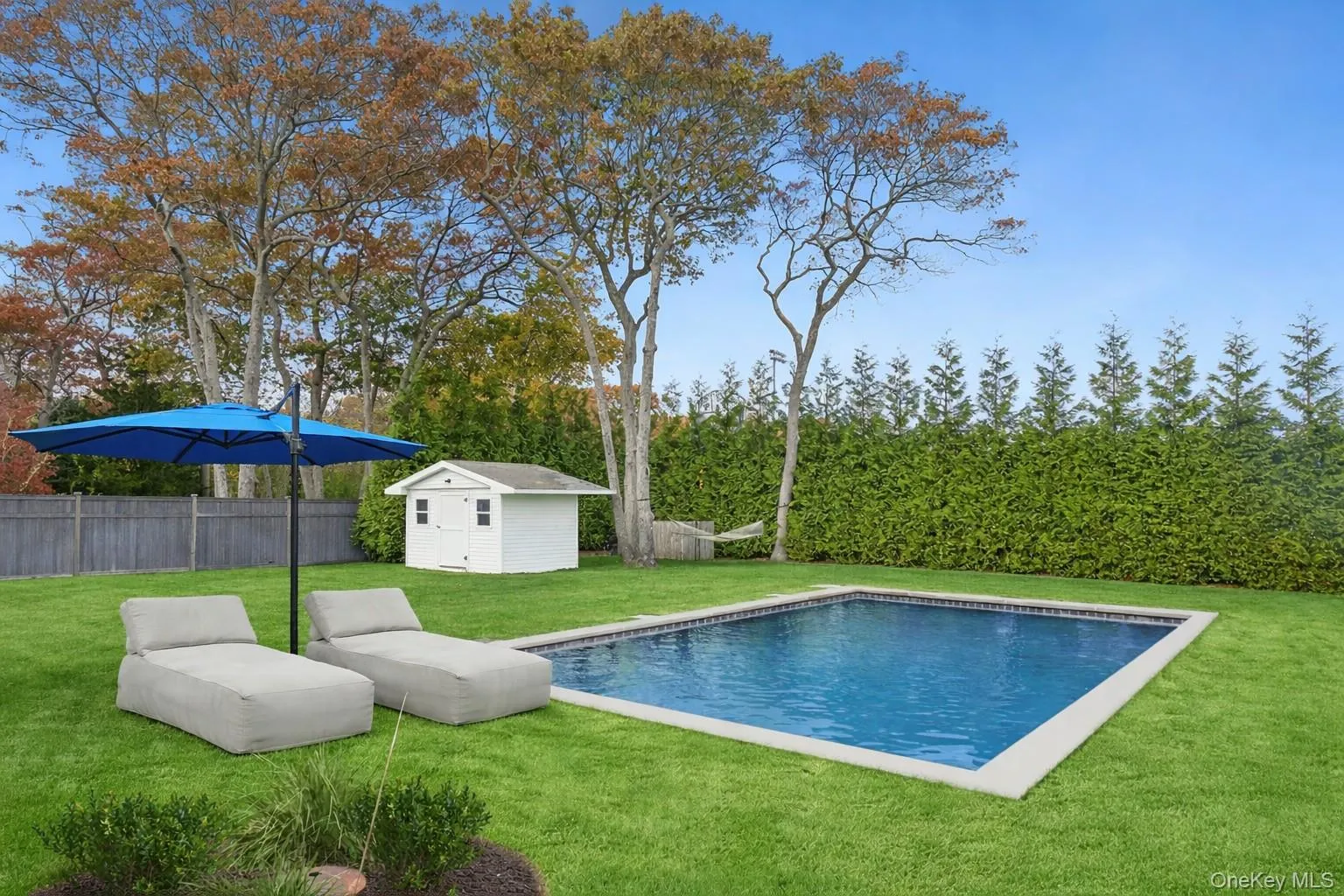 View of heated swimming pool with a fenced backyard, a storage shed, and a patio area View of heated swimming pool with a fenced backyard, a storage shed, and a patio area