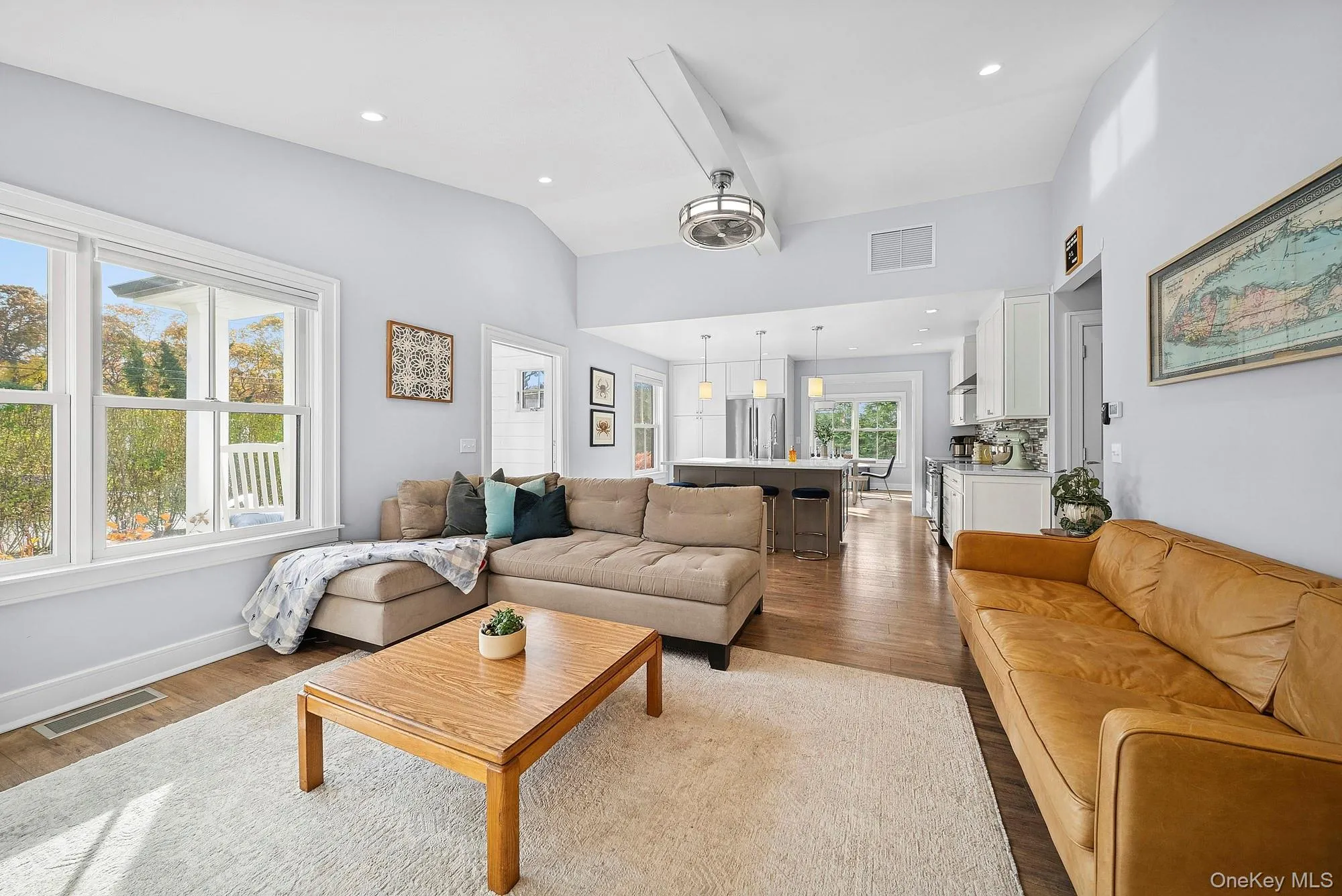 Living area with dark wood finished floors, vaulted ceiling, and recessed lighting Living area with dark wood finished floors, vaulted ceiling, and recessed lighting