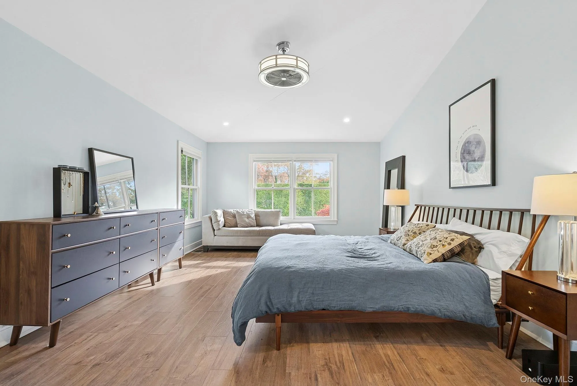 Bedroom featuring light wood finished floors, lofted ceiling, and recessed lighting Bedroom featuring light wood finished floors, lofted ceiling, and recessed lighting
