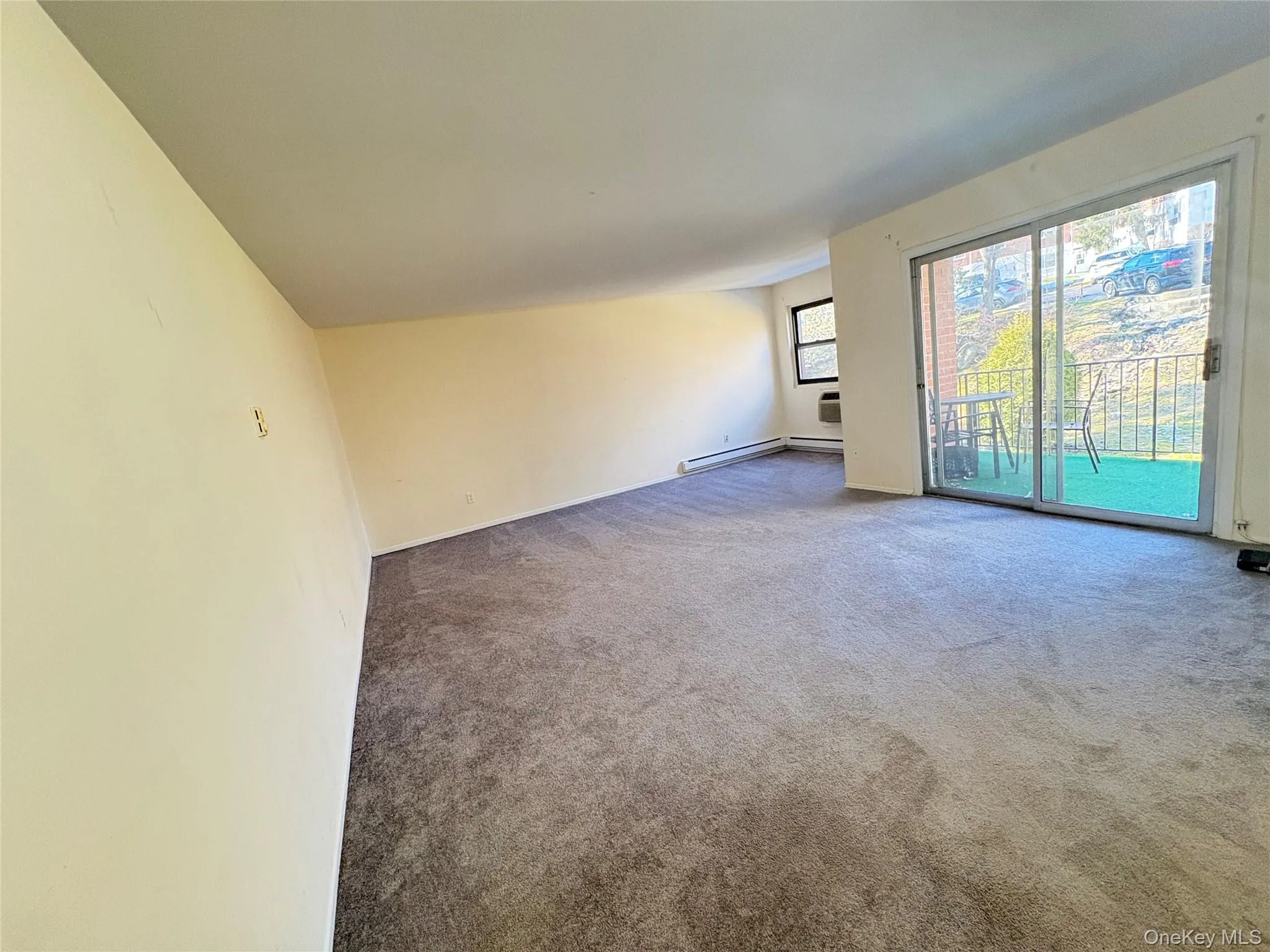 Carpeted spare room with baseboard heating Carpeted spare room with baseboard heating