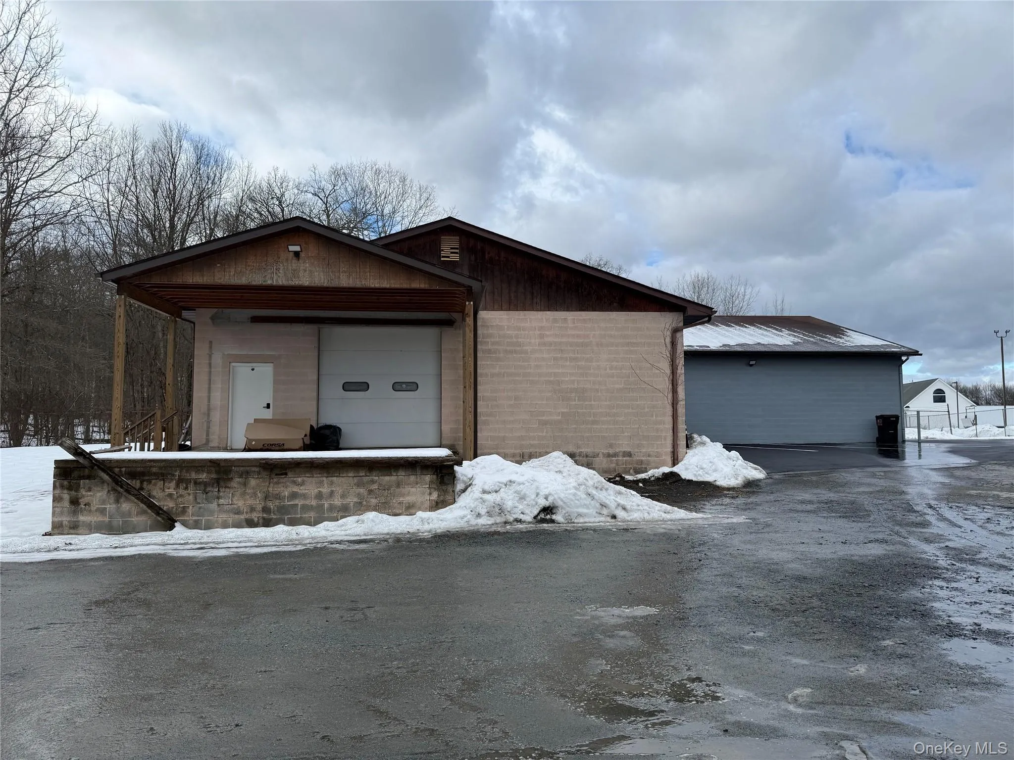 View of front of property with an outbuilding, brick siding, and covered porch View of front of property with an outbuilding, brick siding, and covered porch