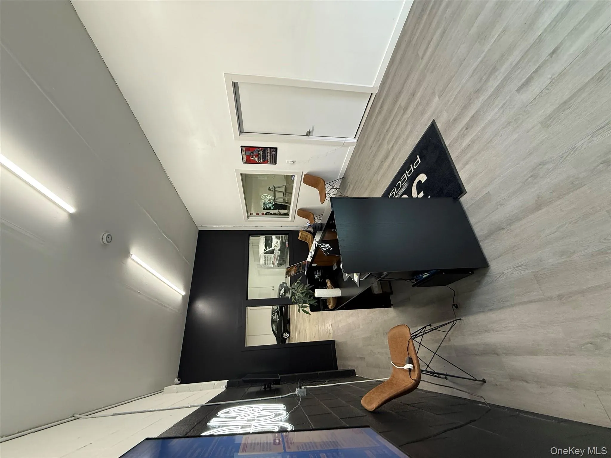 Office space featuring an accent wall and light wood-style floors Office space featuring an accent wall and light wood-style floors