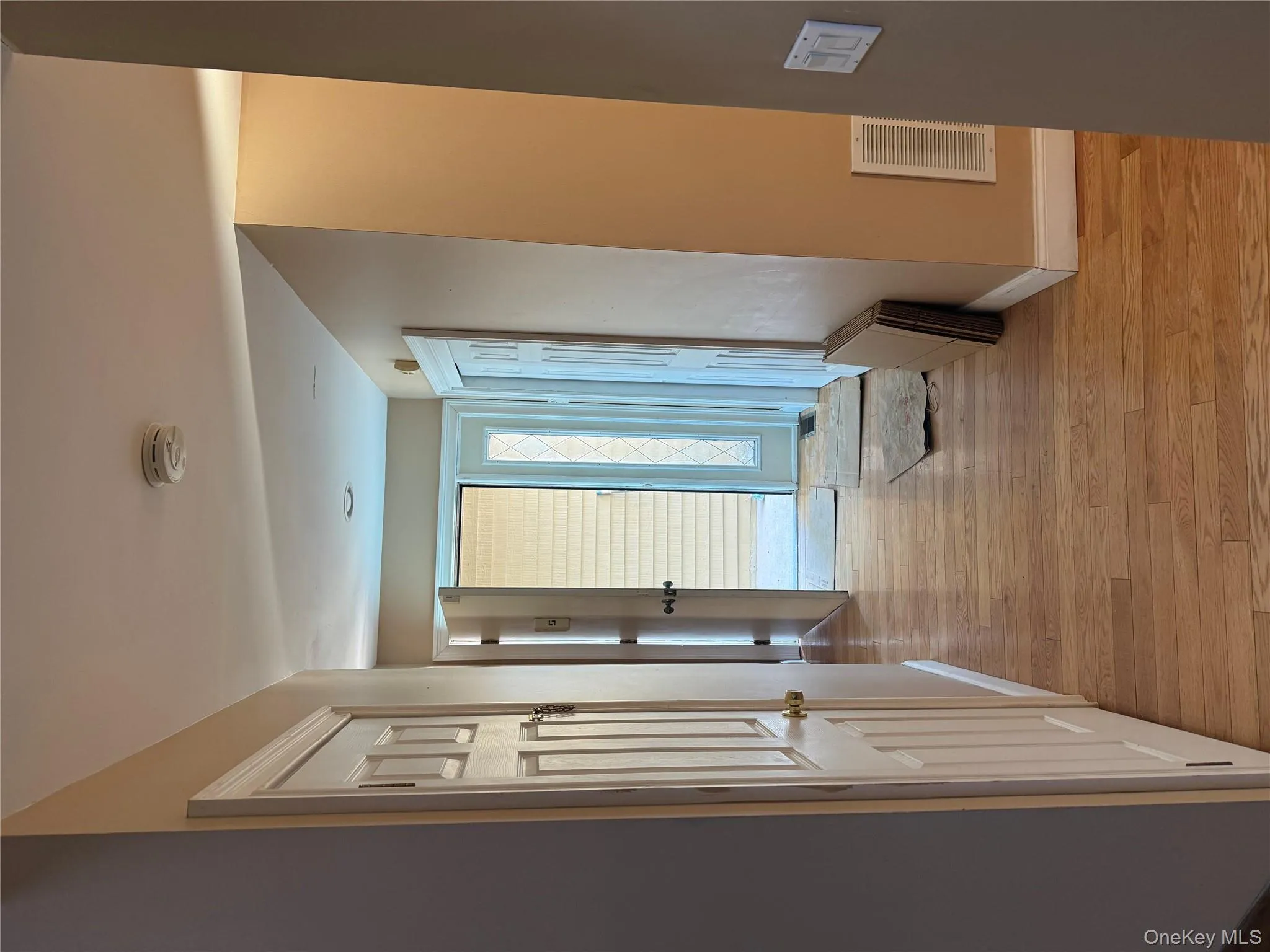 Inviting entryway featuring warm hardwood flooring, recessed lighting, and a front door with decorative sidelights. Inviting entryway featuring warm hardwood flooring, recessed lighting, and a front door with decorative sidelights.