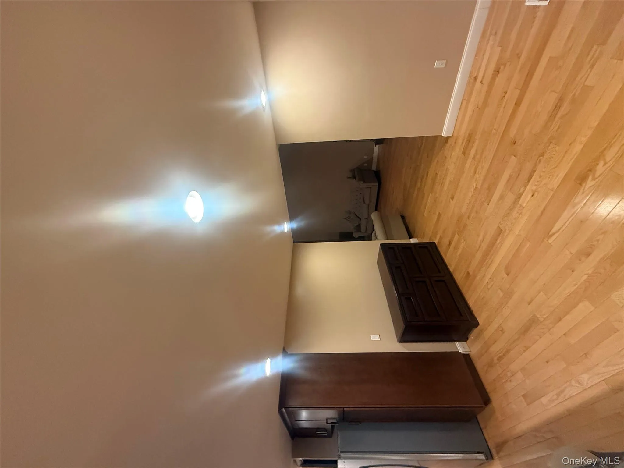 Open-concept living space with hardwood flooring, recessed lighting, and a seamless flow into the adjacent seating area. Open-concept living space with hardwood flooring, recessed lighting, and a seamless flow into the adjacent seating area.