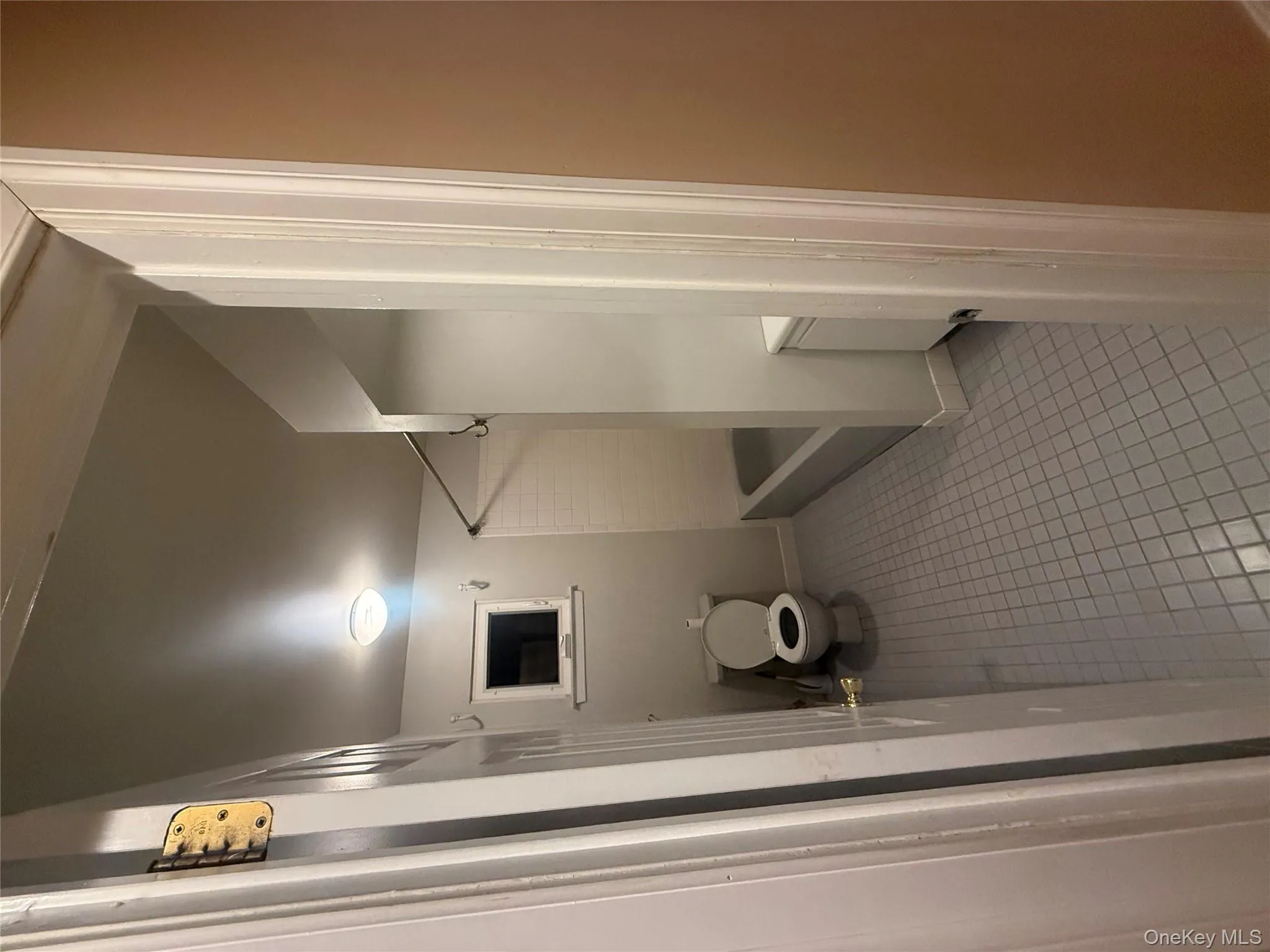 Full bathroom featuring a shower-tub combination, neutral tile flooring, and a white vanity. Full bathroom featuring a shower-tub combination, neutral tile flooring, and a white vanity.