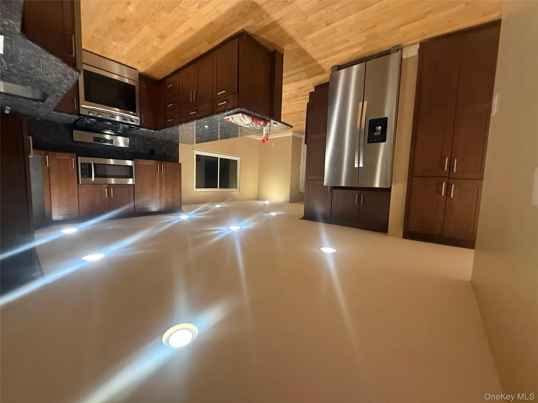 Gourmet kitchen featuring sleek stainless steel appliances, premium granite countertops, and an expansive breakfast bar island. Gourmet kitchen featuring sleek stainless steel appliances, premium granite countertops, and an expansive breakfast bar island.