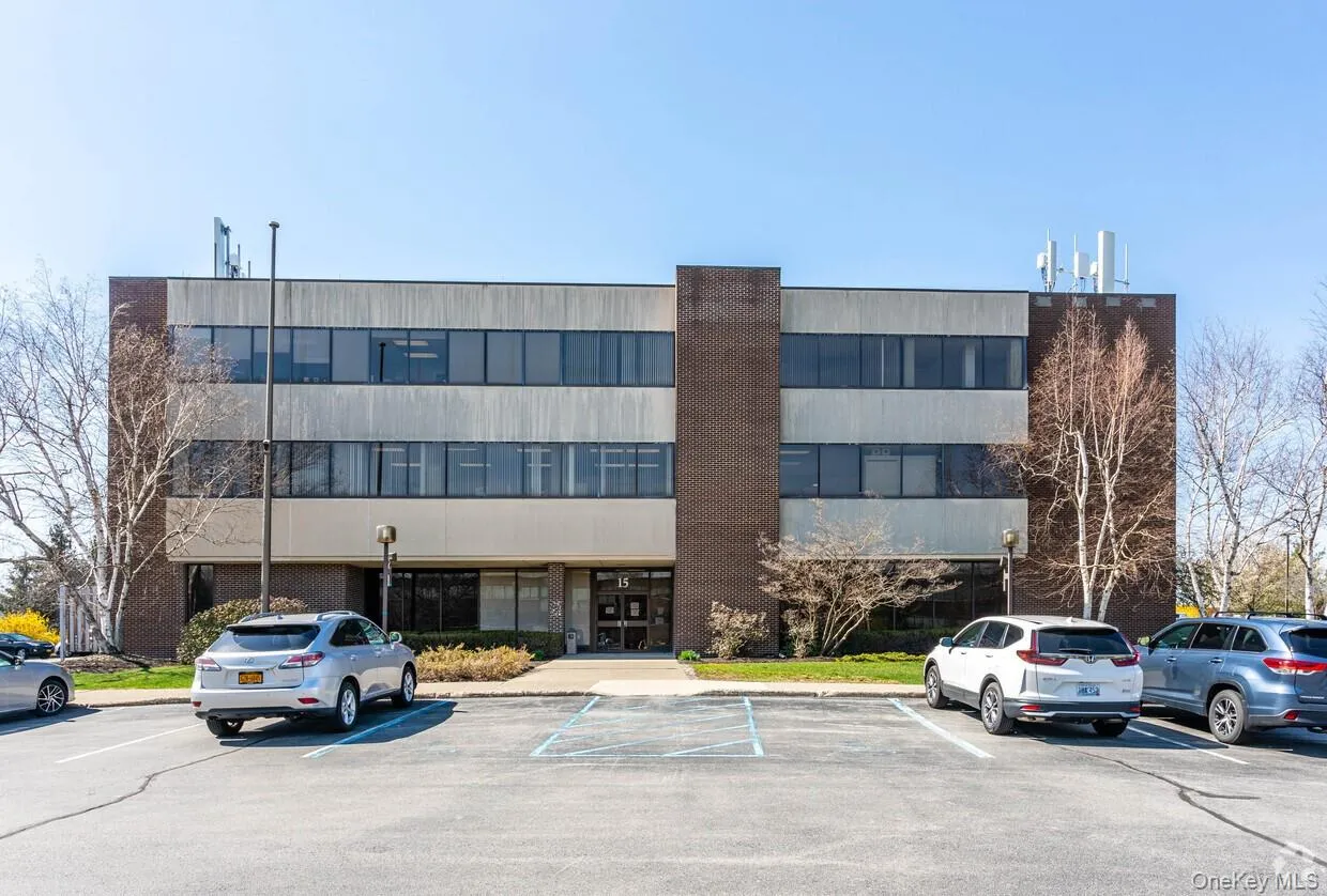 View of building exterior with uncovered parking View of building exterior with uncovered parking