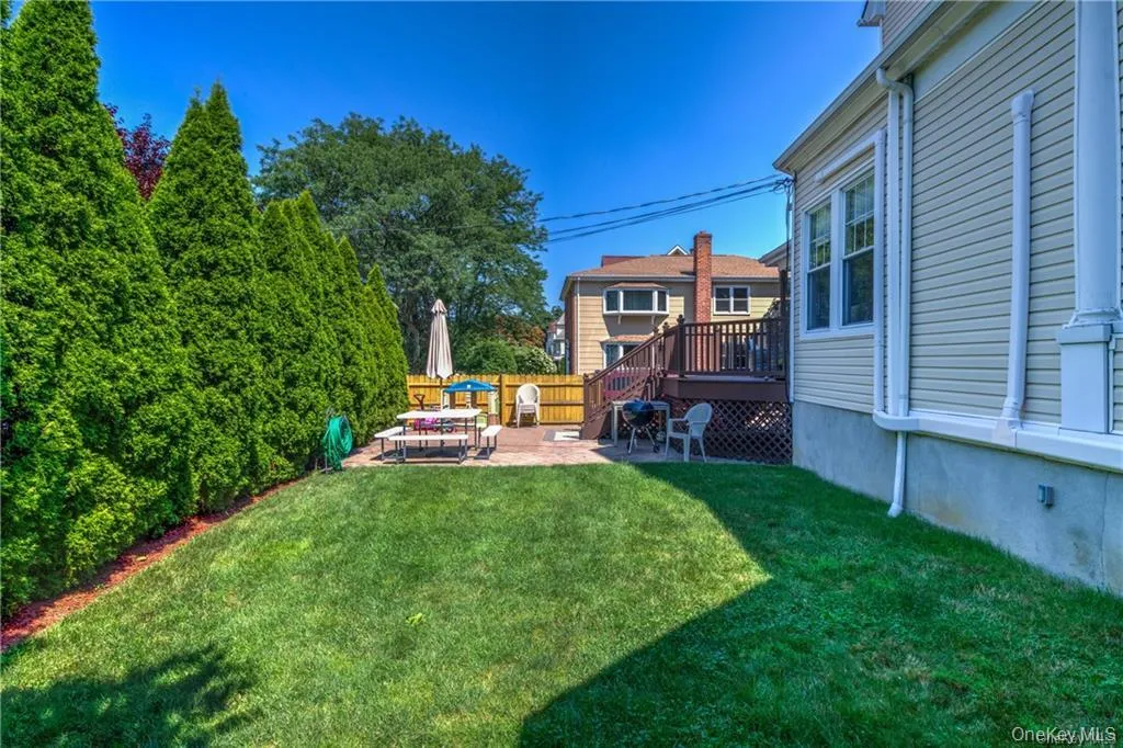 View of yard featuring a patio and a deck View of yard featuring a patio and a deck