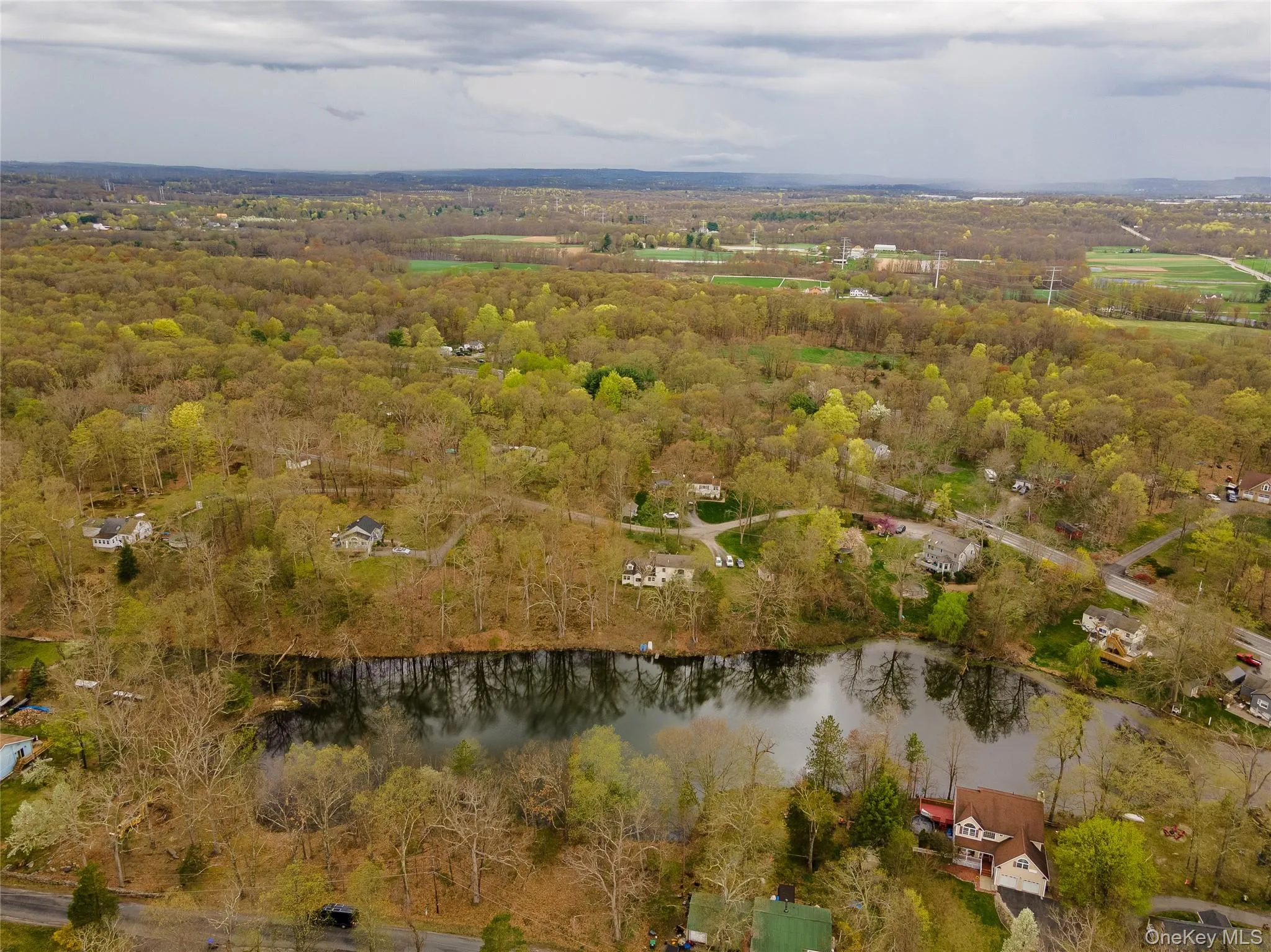 View of property location with a nearby body of water and a forest View of property location with a nearby body of water and a forest