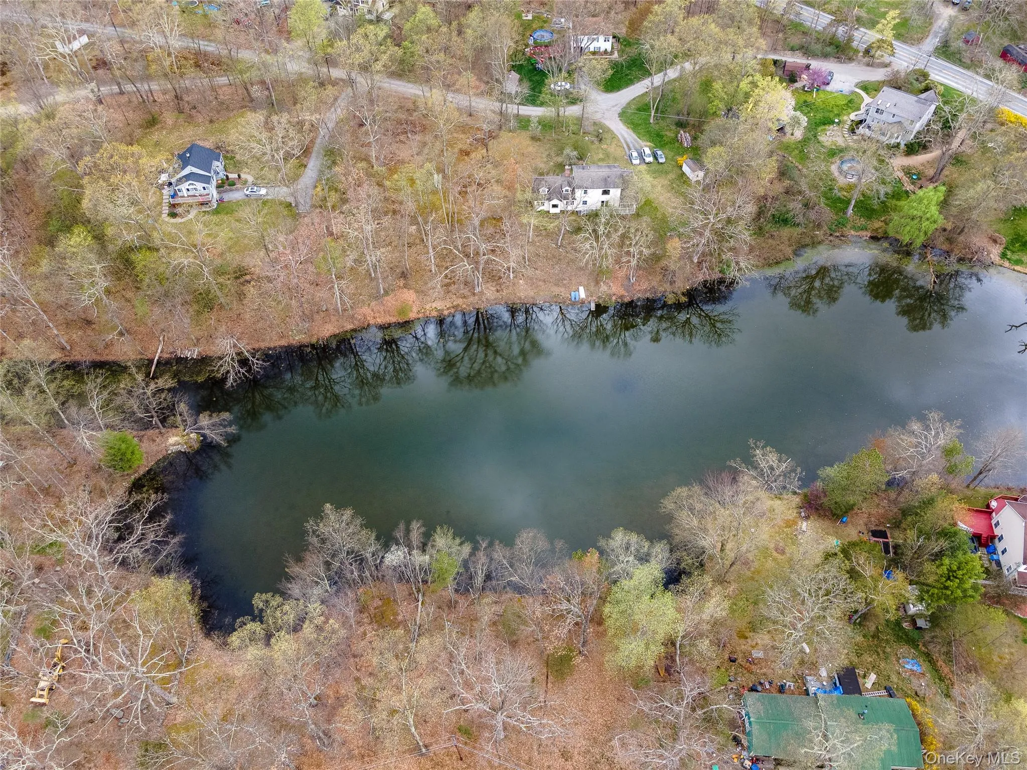 Aerial view of a nearby body of water and a tree filled landscape Aerial view of a nearby body of water and a tree filled landscape