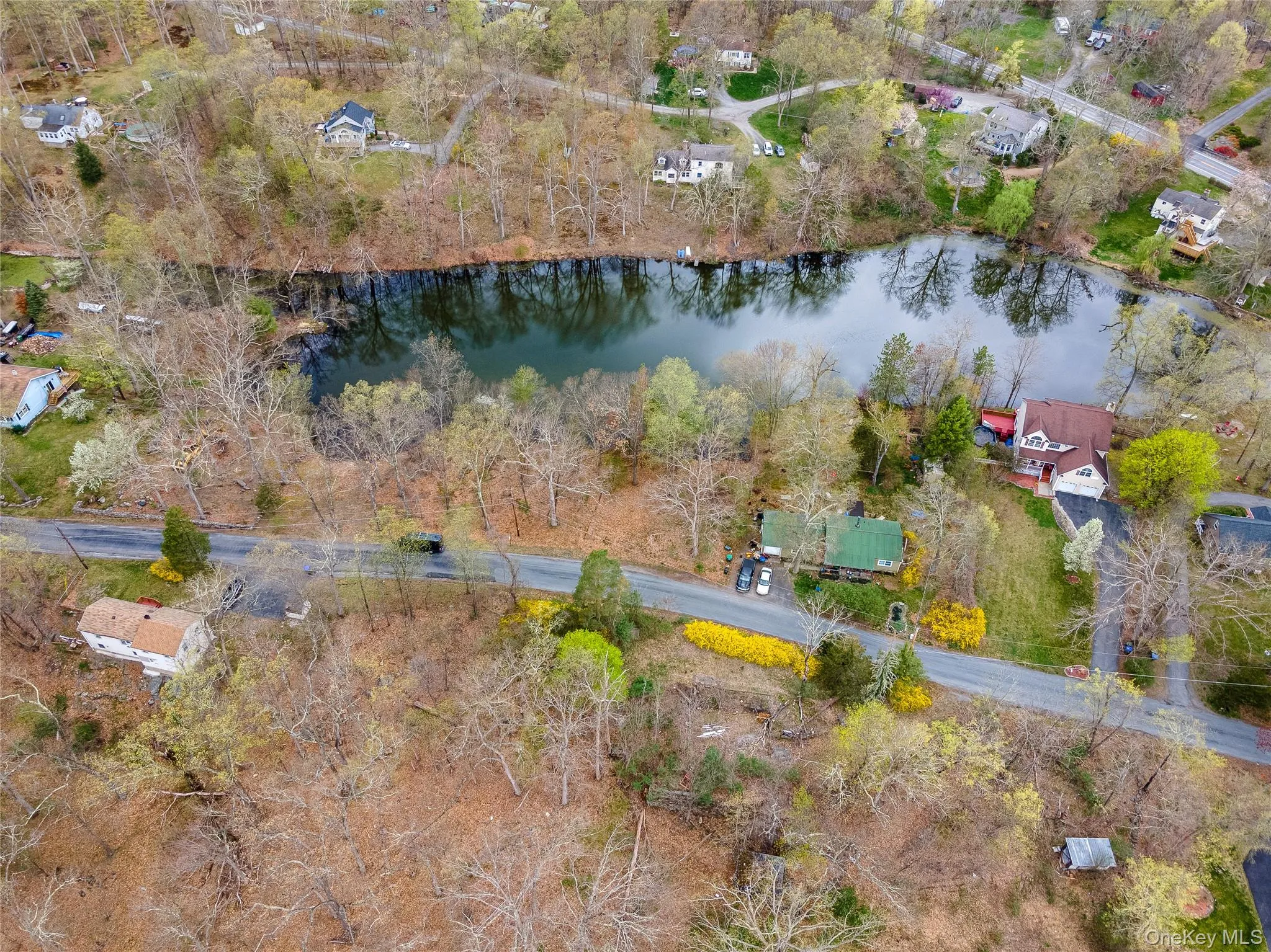 View of property location featuring a large body of water and a tree filled landscape View of property location featuring a large body of water and a tree filled landscape