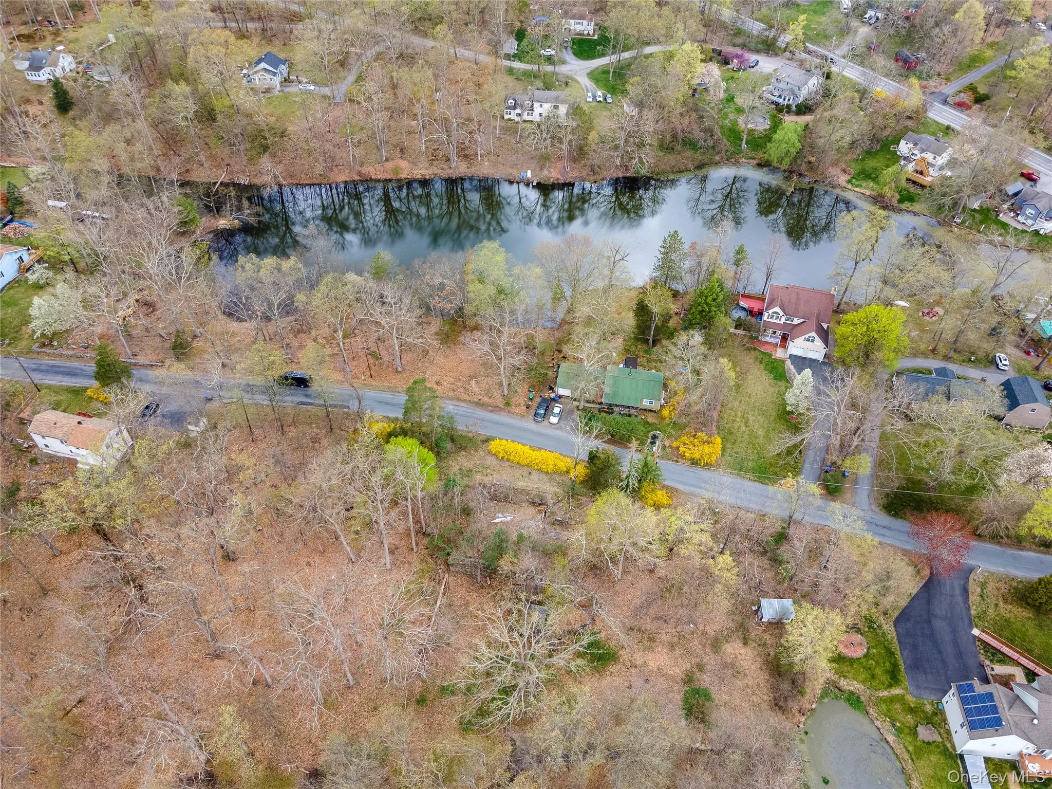 Aerial view of property's location with a nearby body of water Aerial view of property's location with a nearby body of water