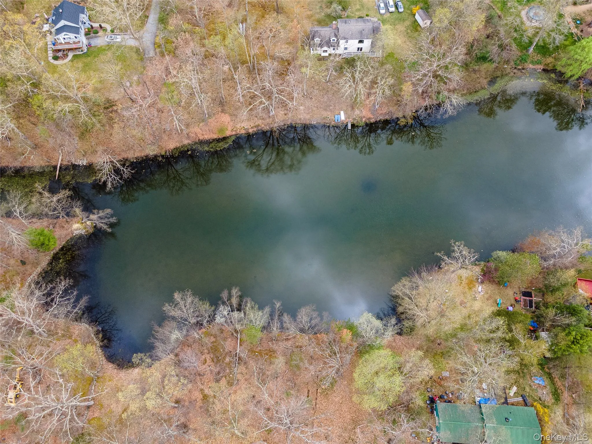 Bird's eye view of a nearby body of water and a tree filled landscape Bird's eye view of a nearby body of water and a tree filled landscape