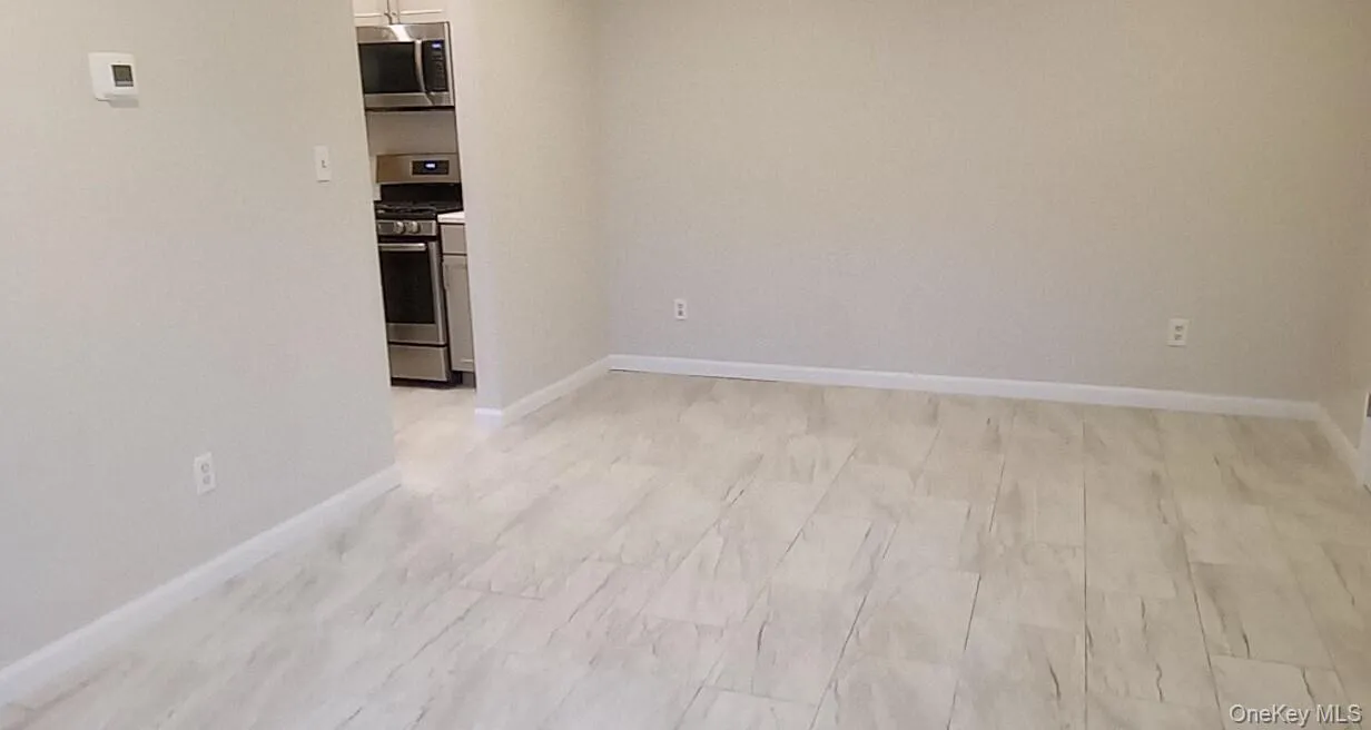 Unfurnished room with baseboards Unfurnished room with baseboards