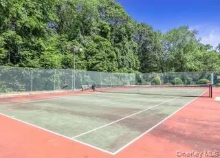 View of tennis court featuring community basketball court View of tennis court featuring community basketball court