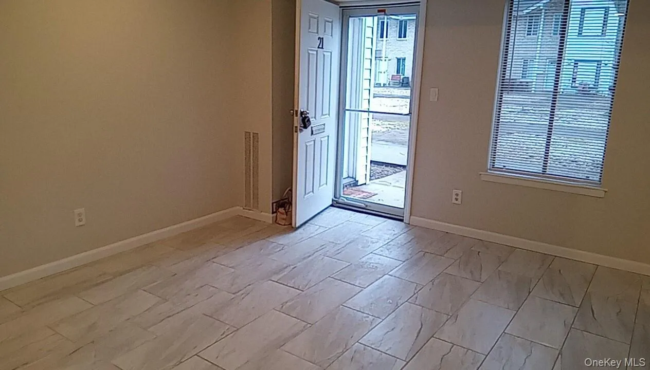 Doorway to outside with baseboards Doorway to outside with baseboards