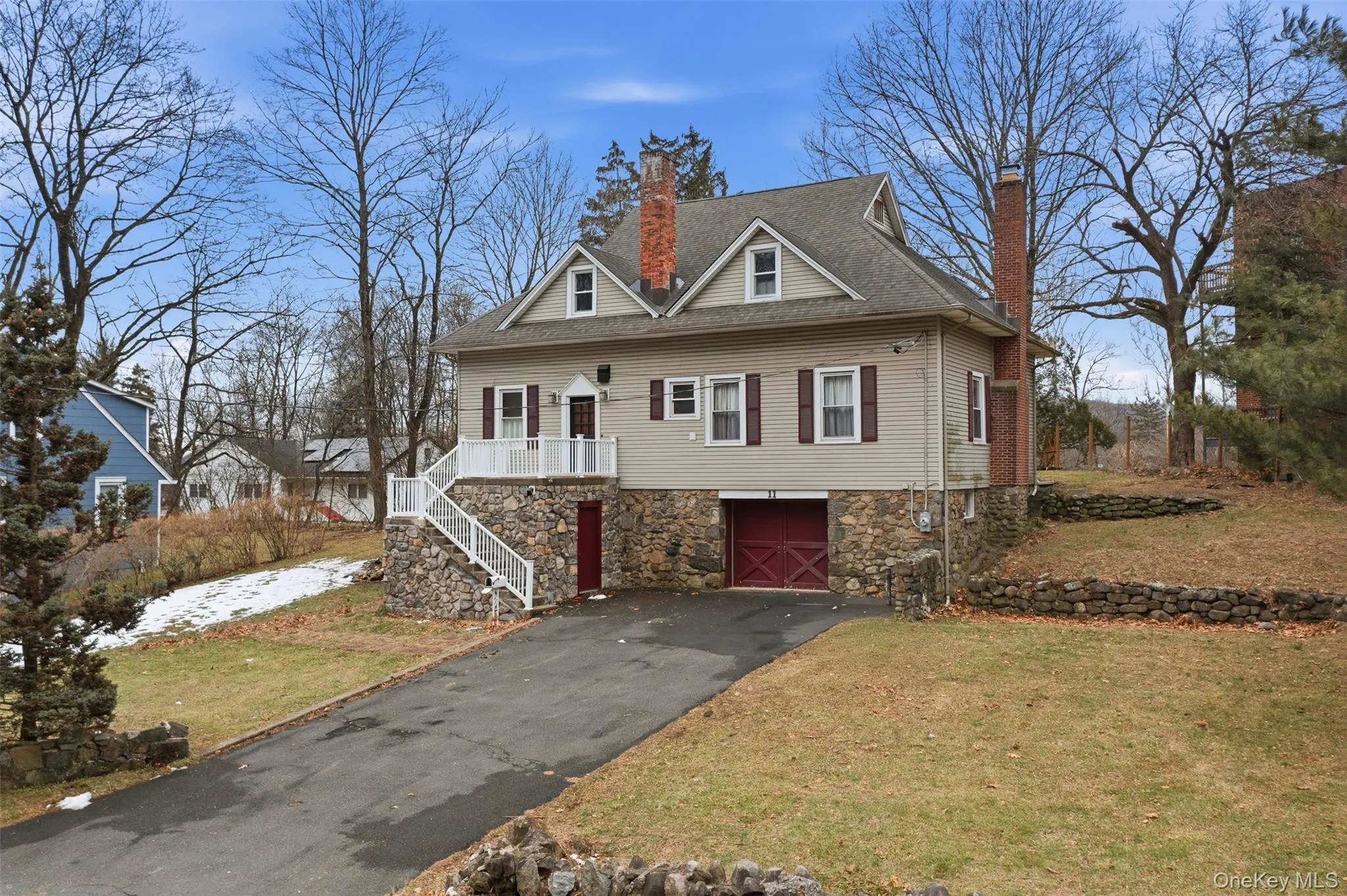 View of front of property with a chimney, driveway, a front yard, and stairs View of front of property with a chimney, driveway, a front yard, and stairs