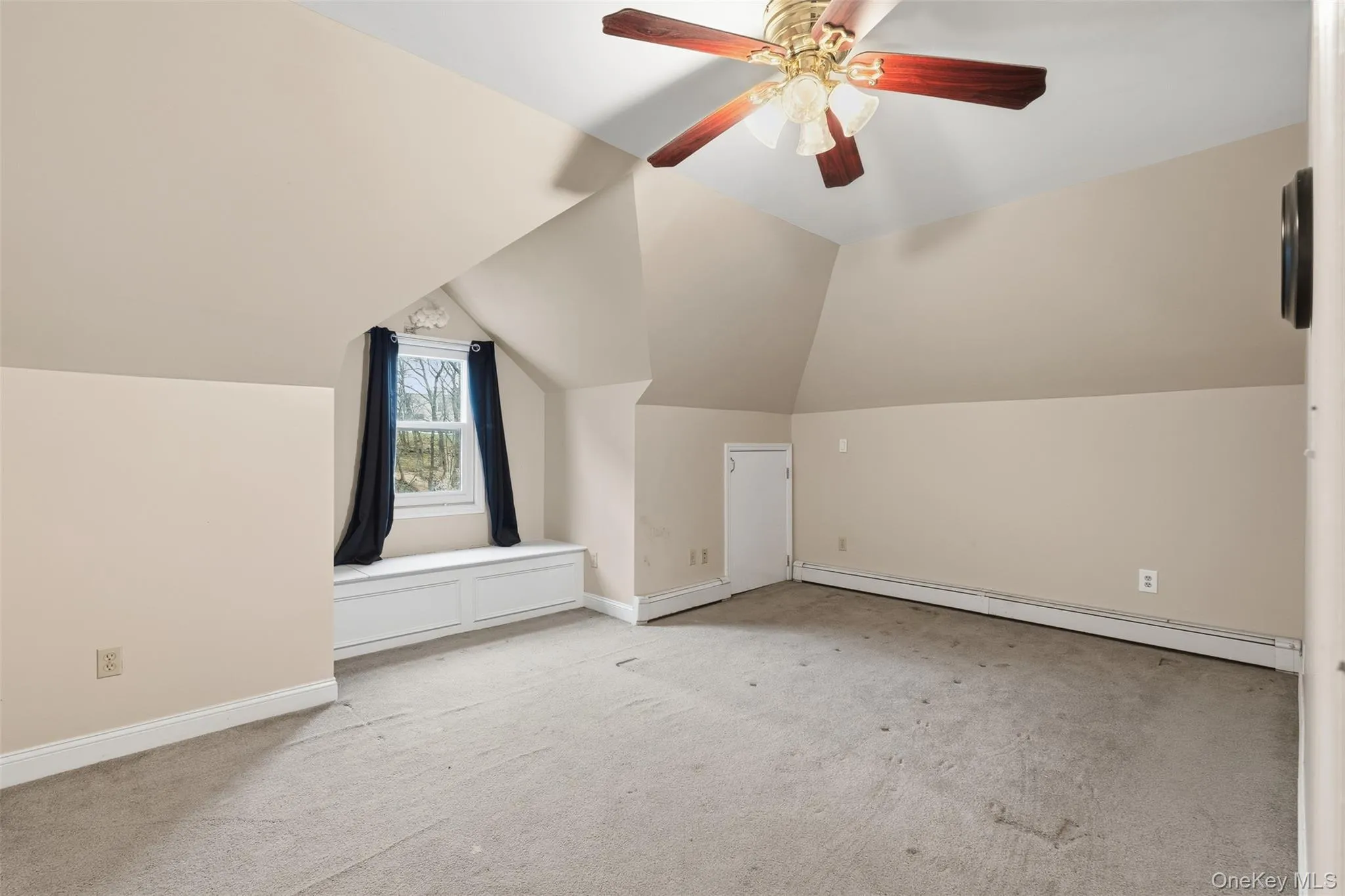 Bonus room with lofted ceiling, a baseboard radiator, light carpet, and ceiling fan Bonus room with lofted ceiling, a baseboard radiator, light carpet, and ceiling fan