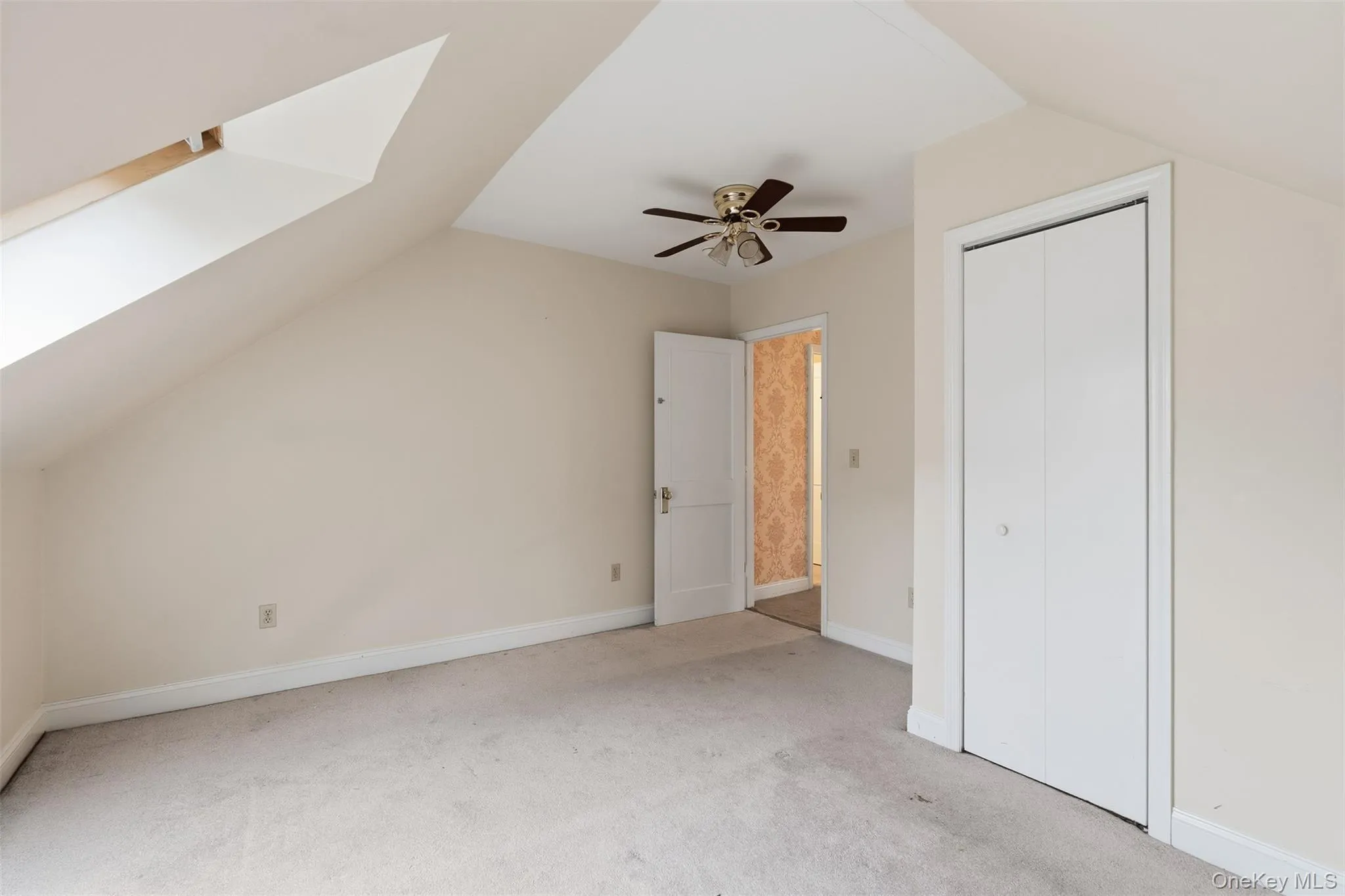 Additional living space featuring carpet flooring, lofted ceiling, and a skylight Additional living space featuring carpet flooring, lofted ceiling, and a skylight