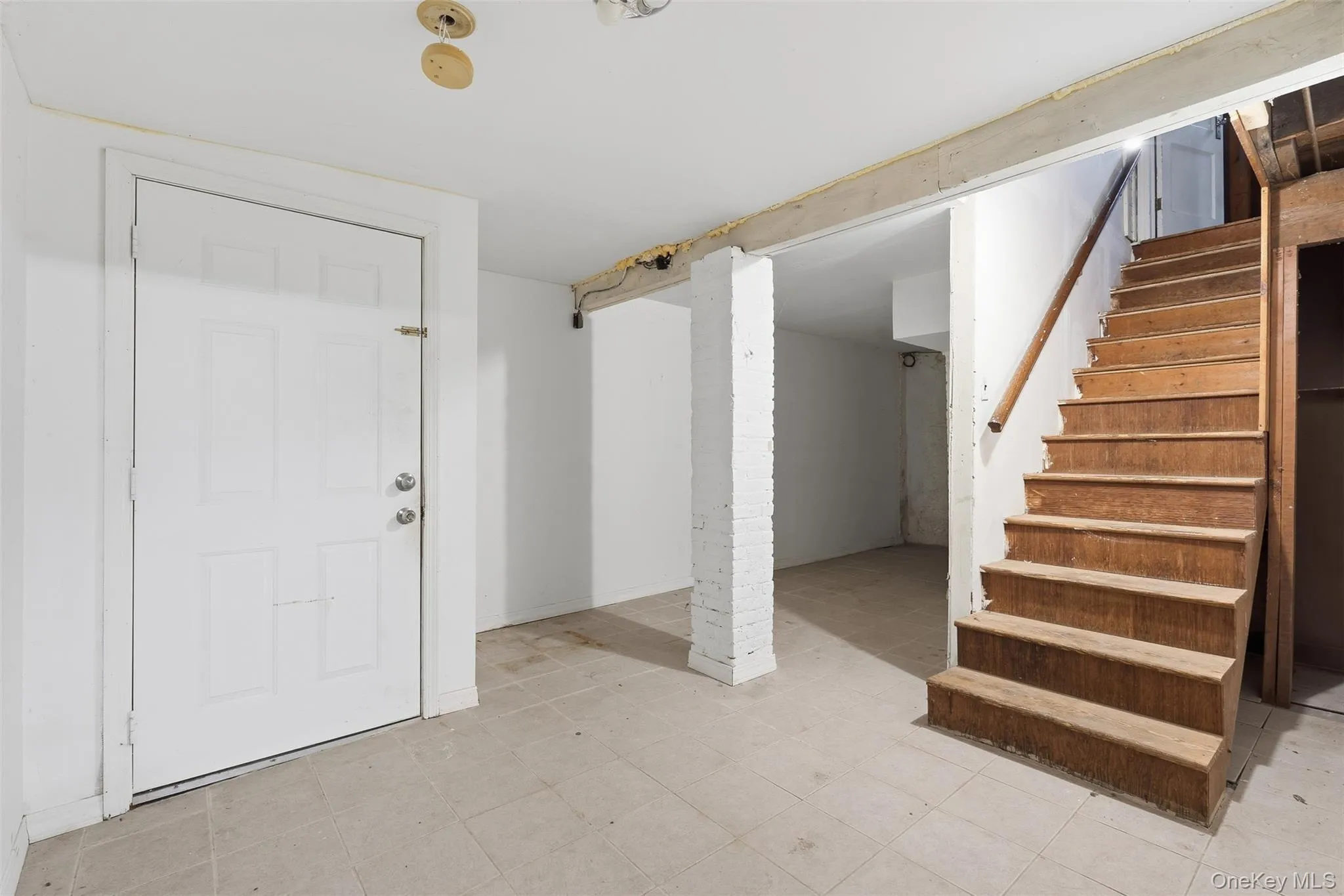 Foyer with stairway and light floors Foyer with stairway and light floors