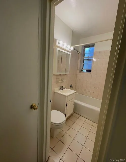 Full bath with vanity, light tile patterned floors, and tub / shower combination Full bath with vanity, light tile patterned floors, and tub / shower combination