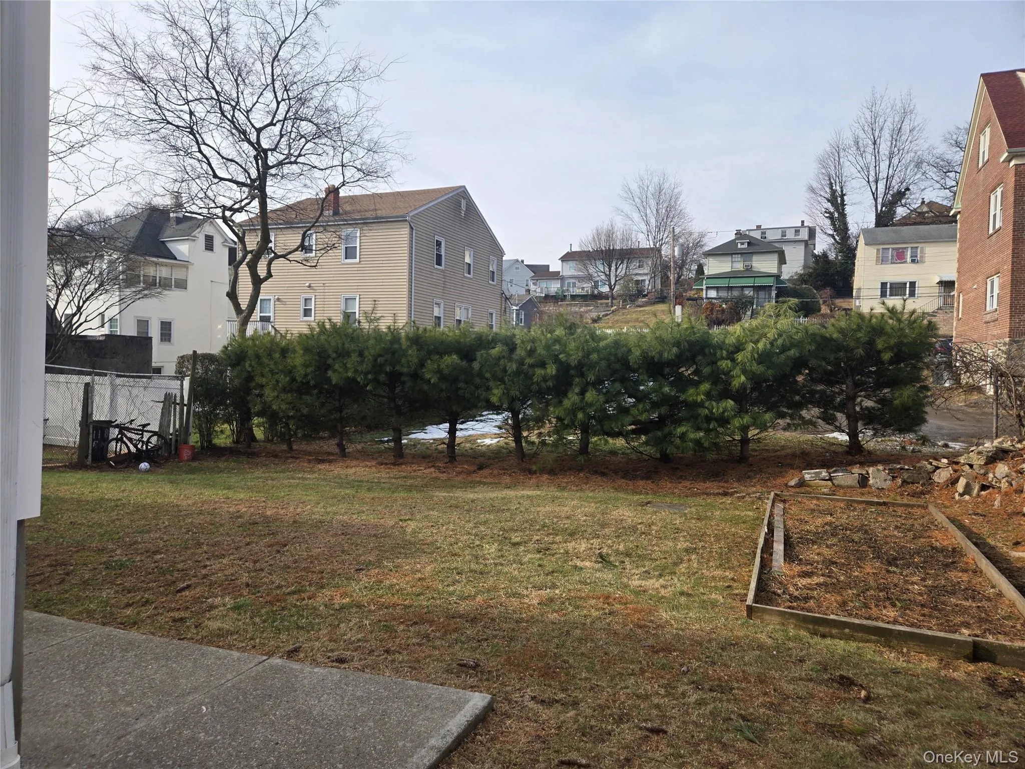 View of grassy yard with a vegetable garden View of grassy yard with a vegetable garden