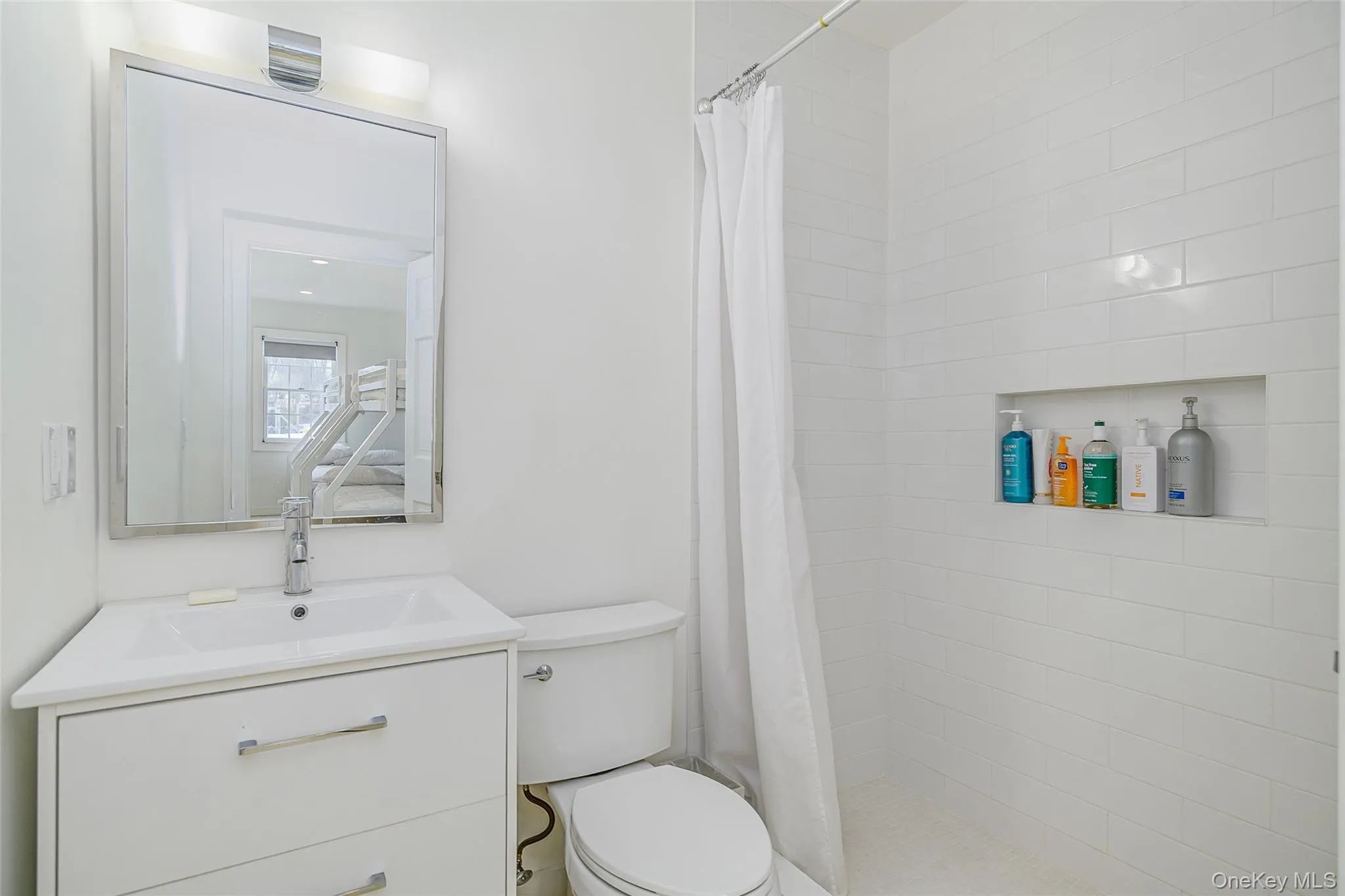 Full bath featuring a shower stall and vanity Full bath featuring a shower stall and vanity
