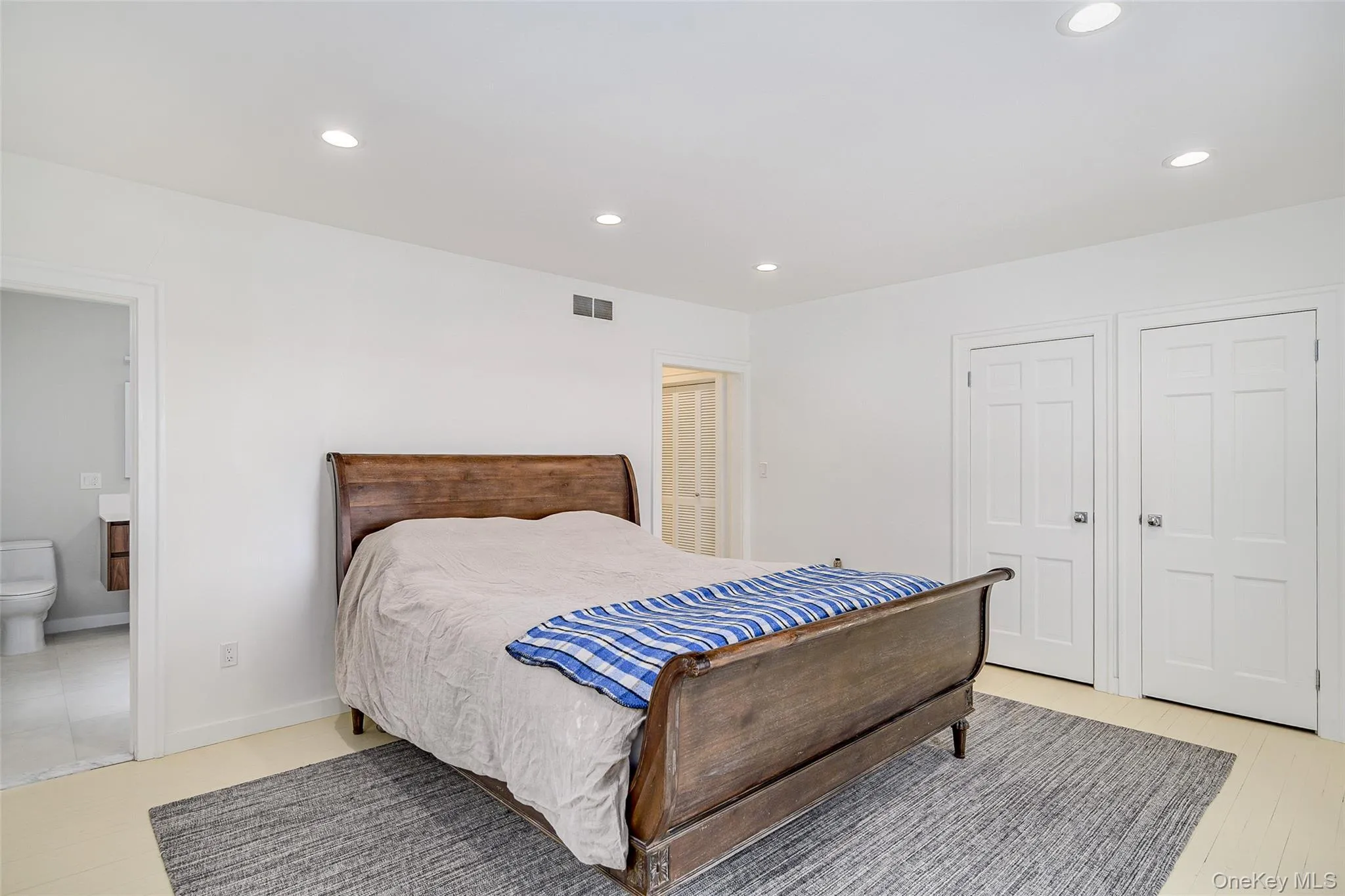 Bedroom with recessed lighting and ensuite bath Bedroom with recessed lighting and ensuite bath