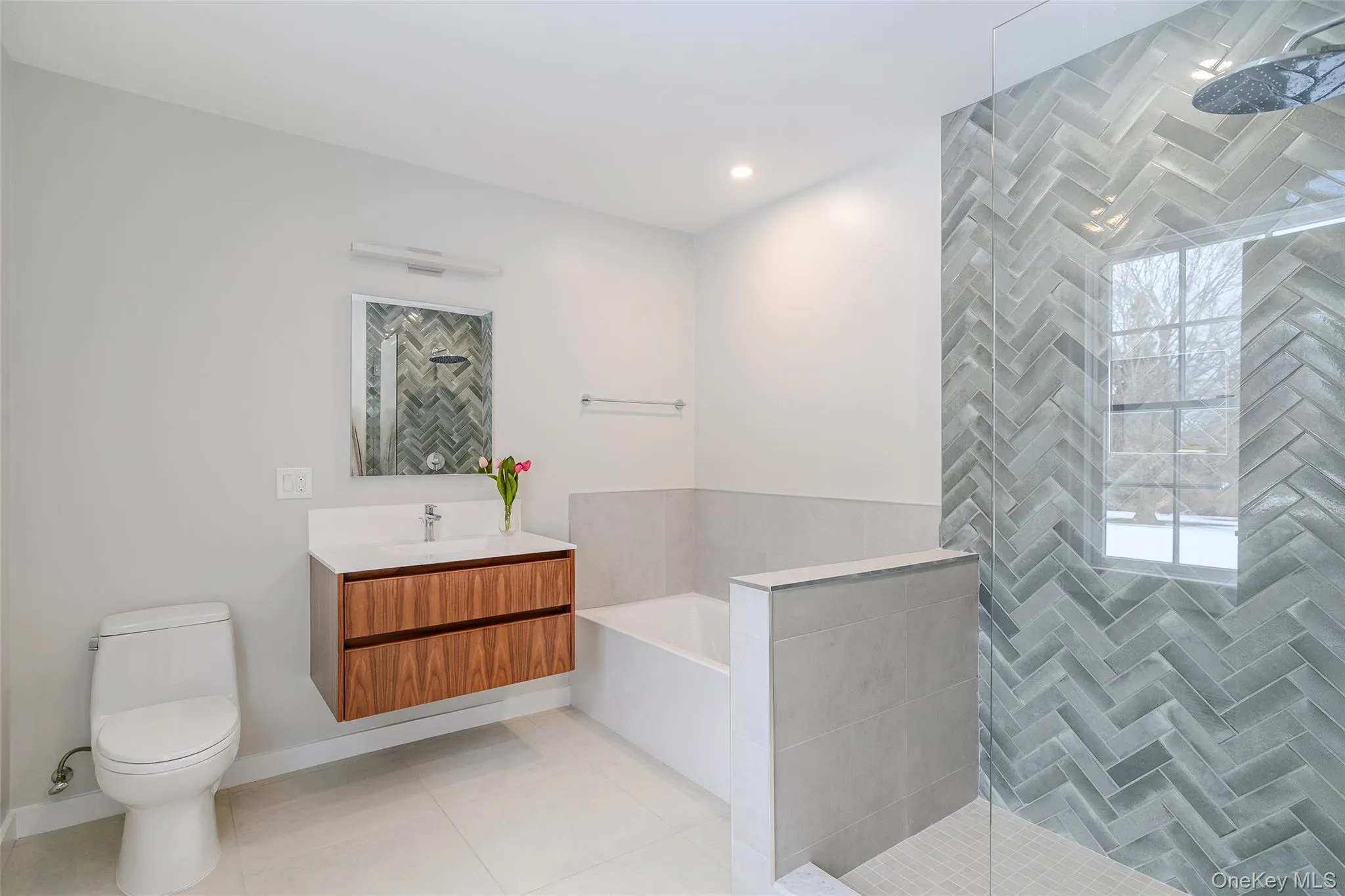Bathroom featuring vanity, walk in shower, a garden tub, light tile patterned floors, and recessed lighting Bathroom featuring vanity, walk in shower, a garden tub, light tile patterned floors, and recessed lighting