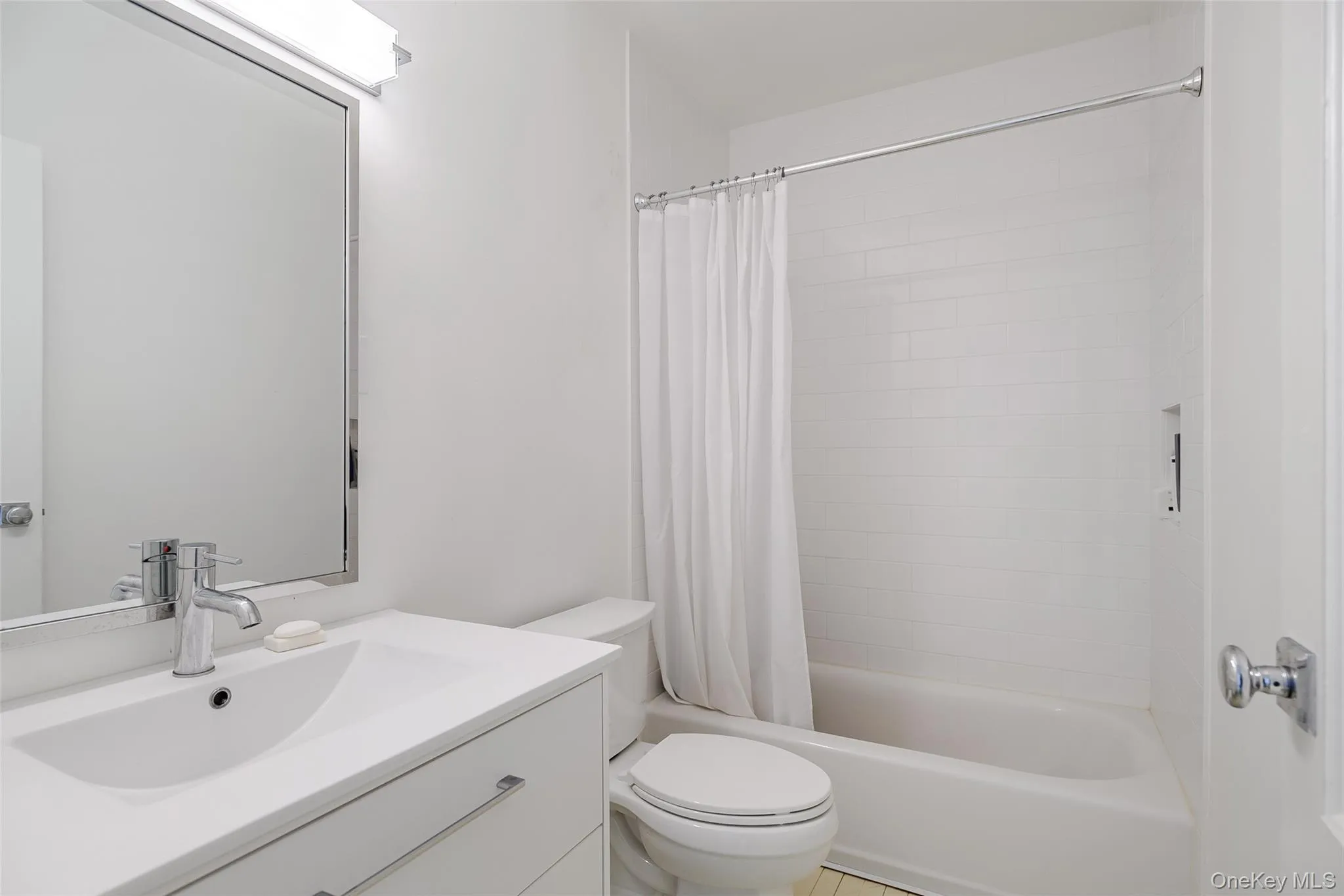 Full bath featuring vanity and shower / bath combo with shower curtain Full bath featuring vanity and shower / bath combo with shower curtain