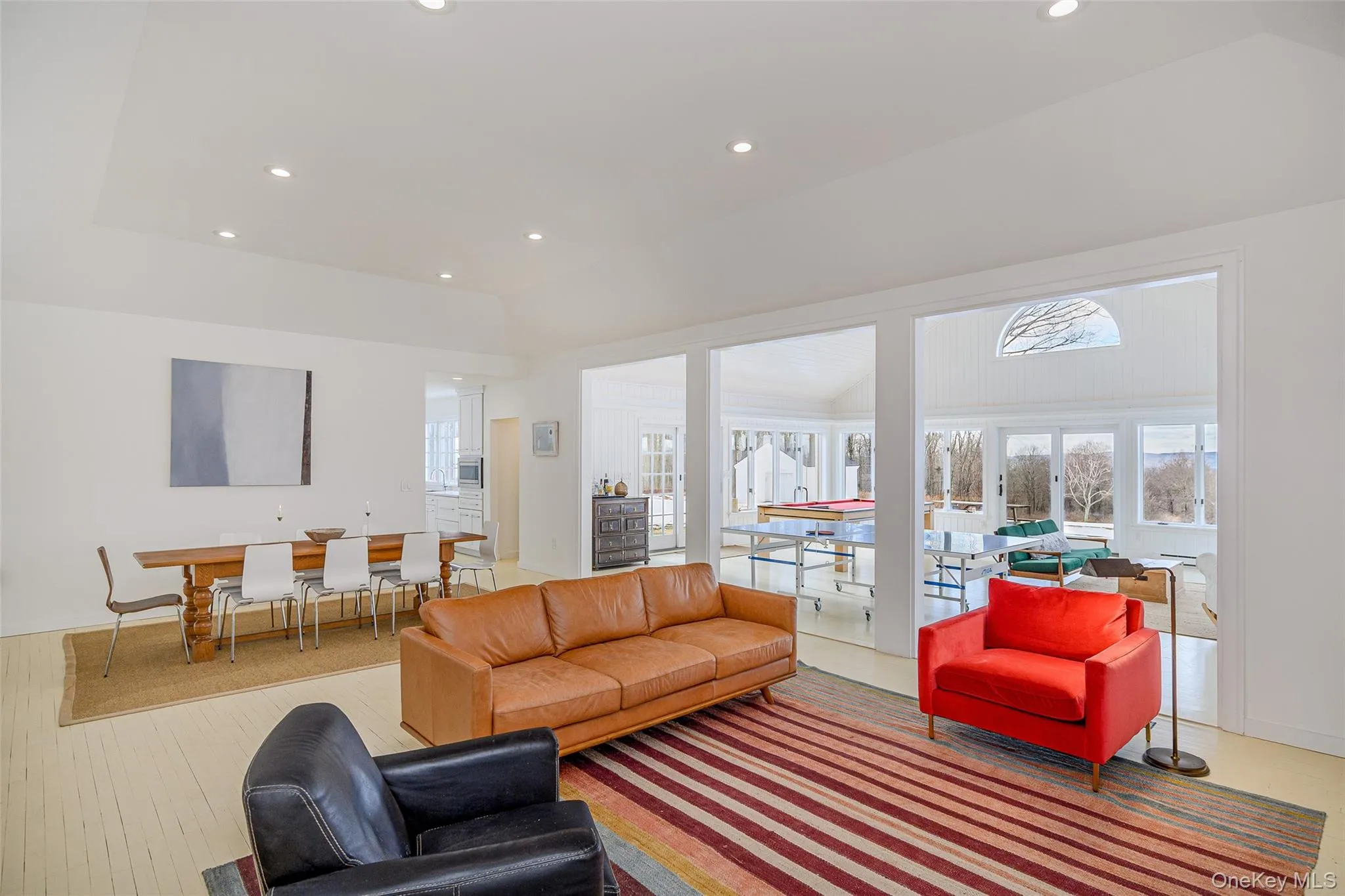 Living room featuring recessed lighting and a tray ceiling Living room featuring recessed lighting and a tray ceiling