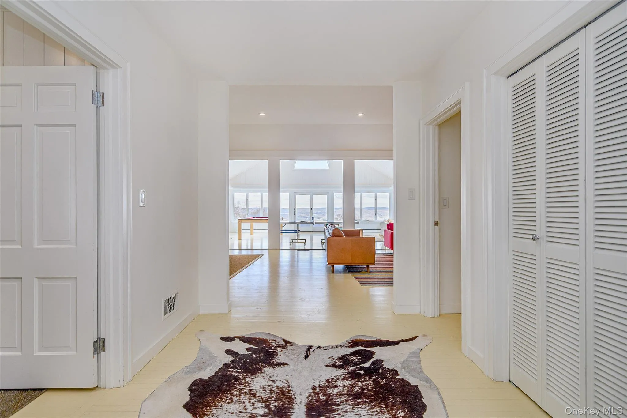 Hallway with recessed lighting and light wood-style flooring Hallway with recessed lighting and light wood-style flooring