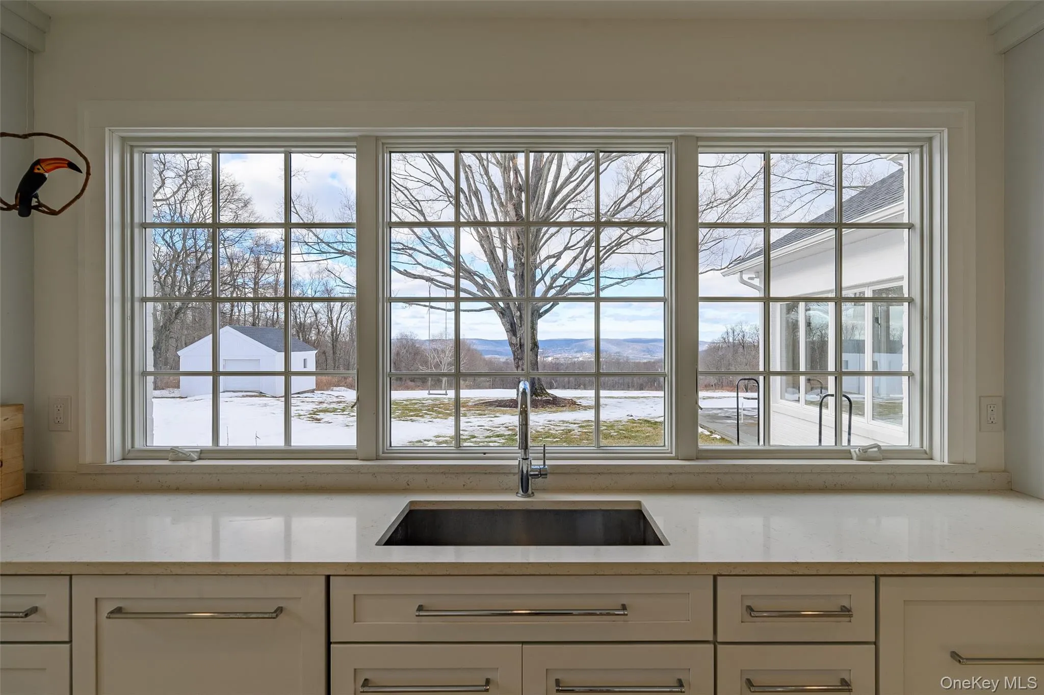 Kitchen with light stone counters and healthy amount of natural light Kitchen with light stone counters and healthy amount of natural light