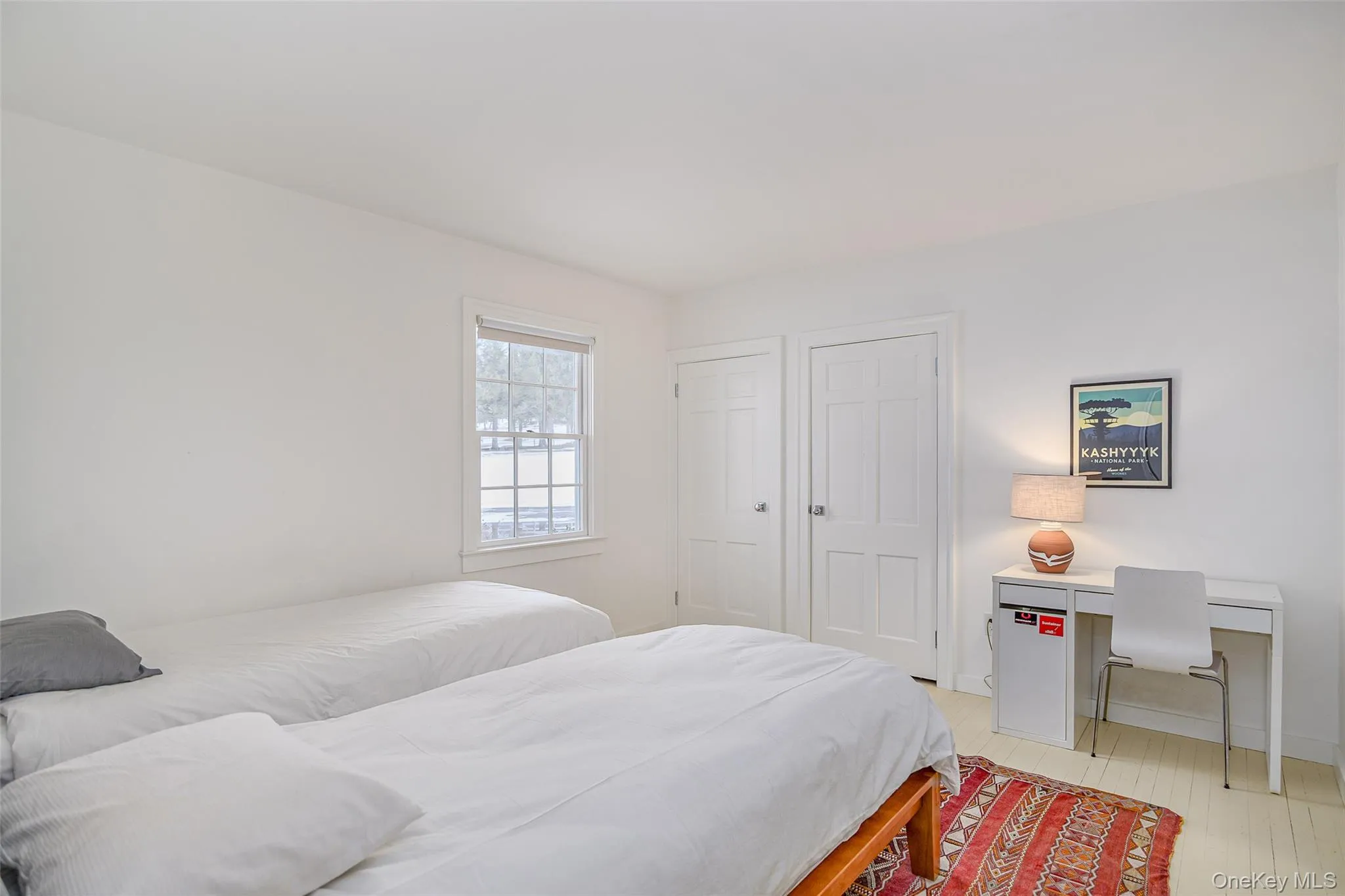 Bedroom featuring light wood finished floors and baseboards Bedroom featuring light wood finished floors and baseboards