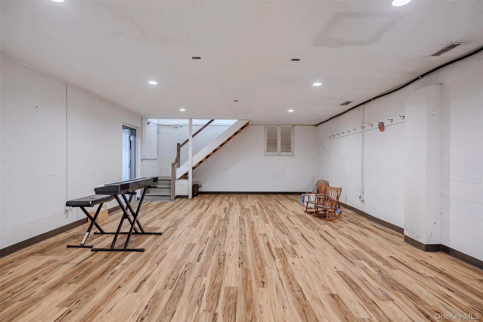 Unfurnished room with stairs and recessed lighting Unfurnished room with stairs and recessed lighting