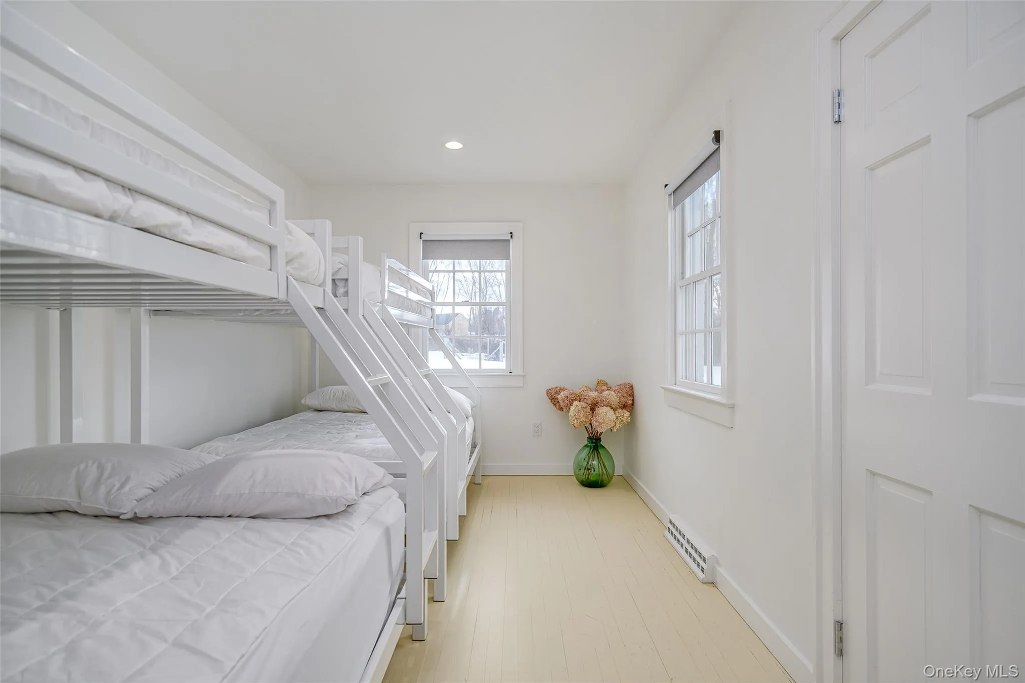 Bedroom featuring light wood-style flooring and recessed lighting Bedroom featuring light wood-style flooring and recessed lighting