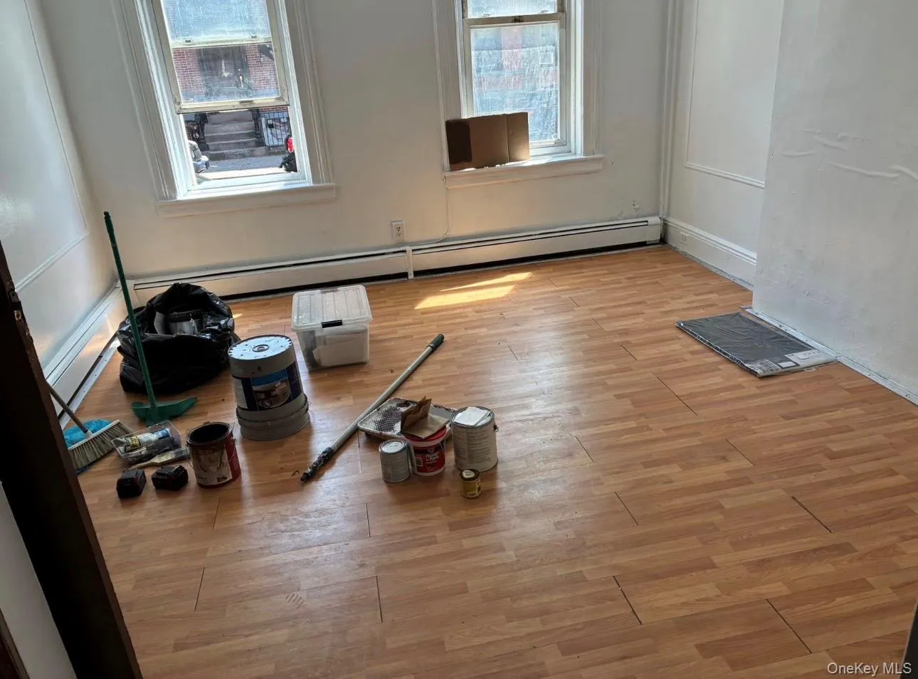 Spare room with baseboard heating and light wood-style floors Spare room with baseboard heating and light wood-style floors