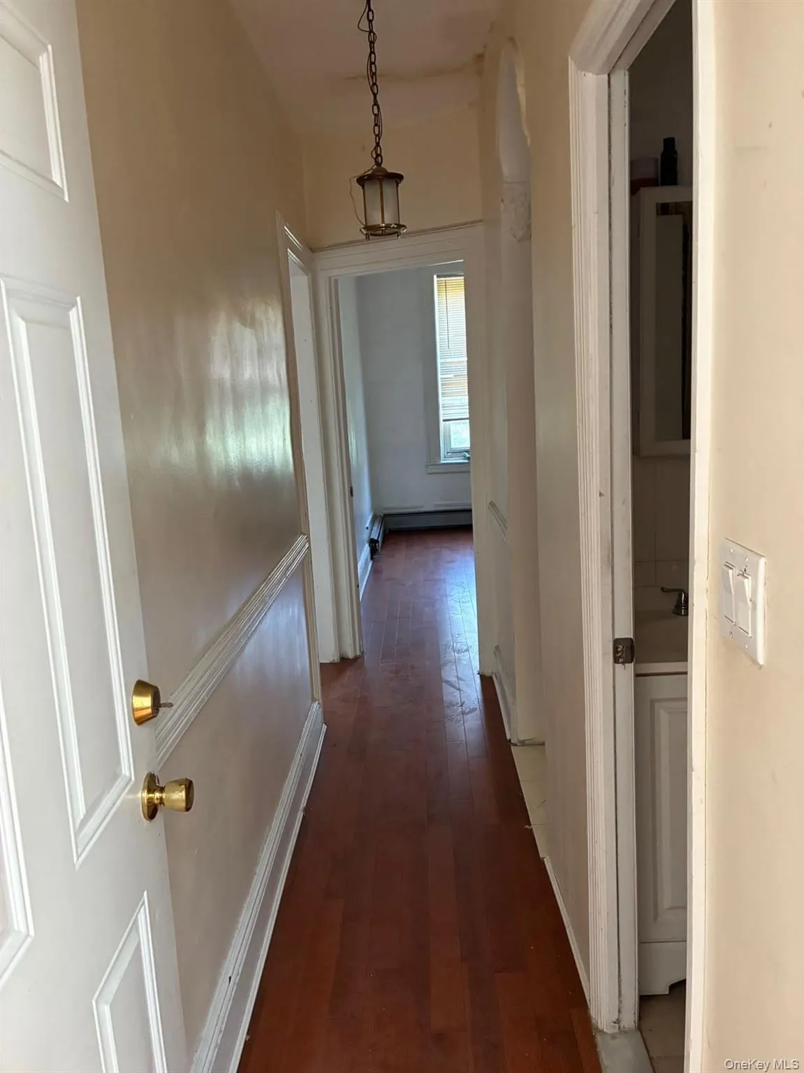 Hallway featuring dark wood-style flooring Hallway featuring dark wood-style flooring