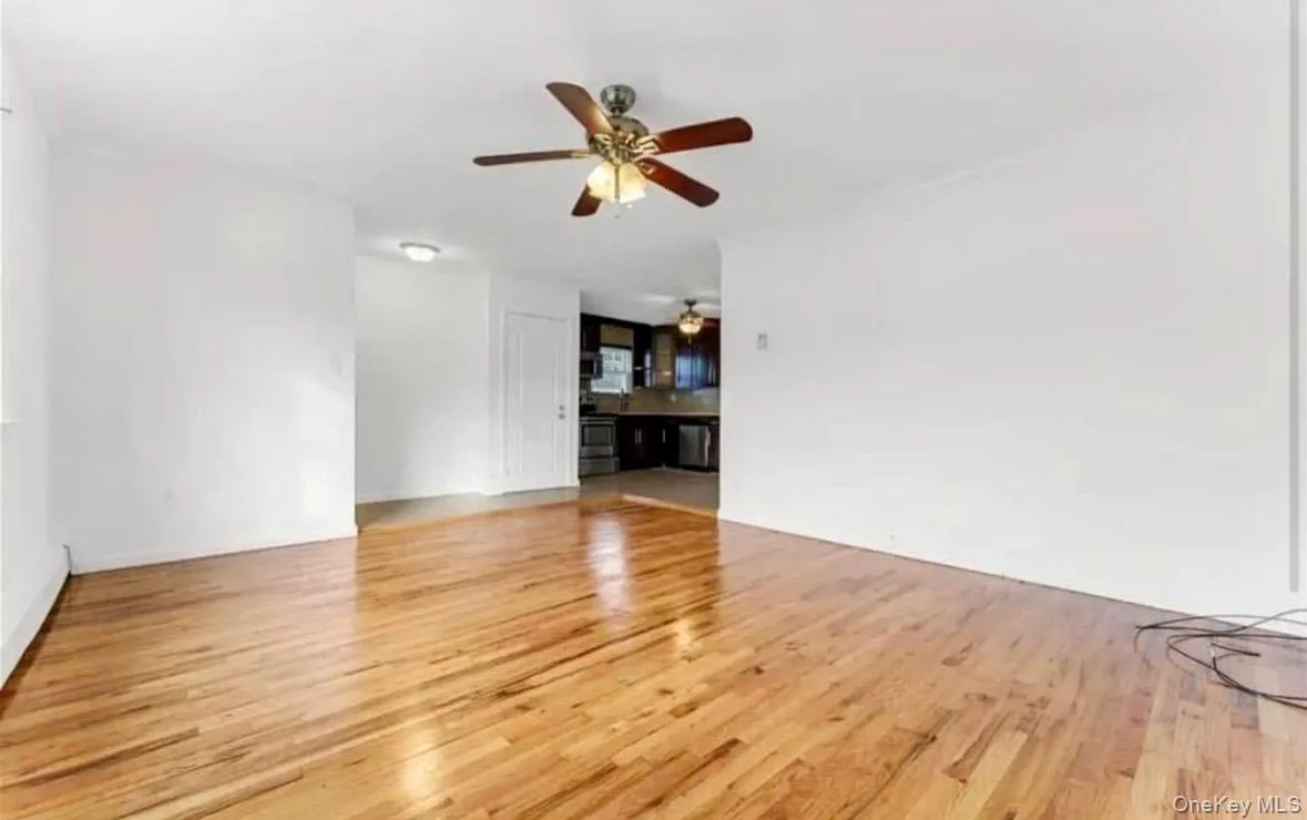 Unfurnished living room featuring light wood-style flooring and ceiling fan Unfurnished living room featuring light wood-style flooring and ceiling fan