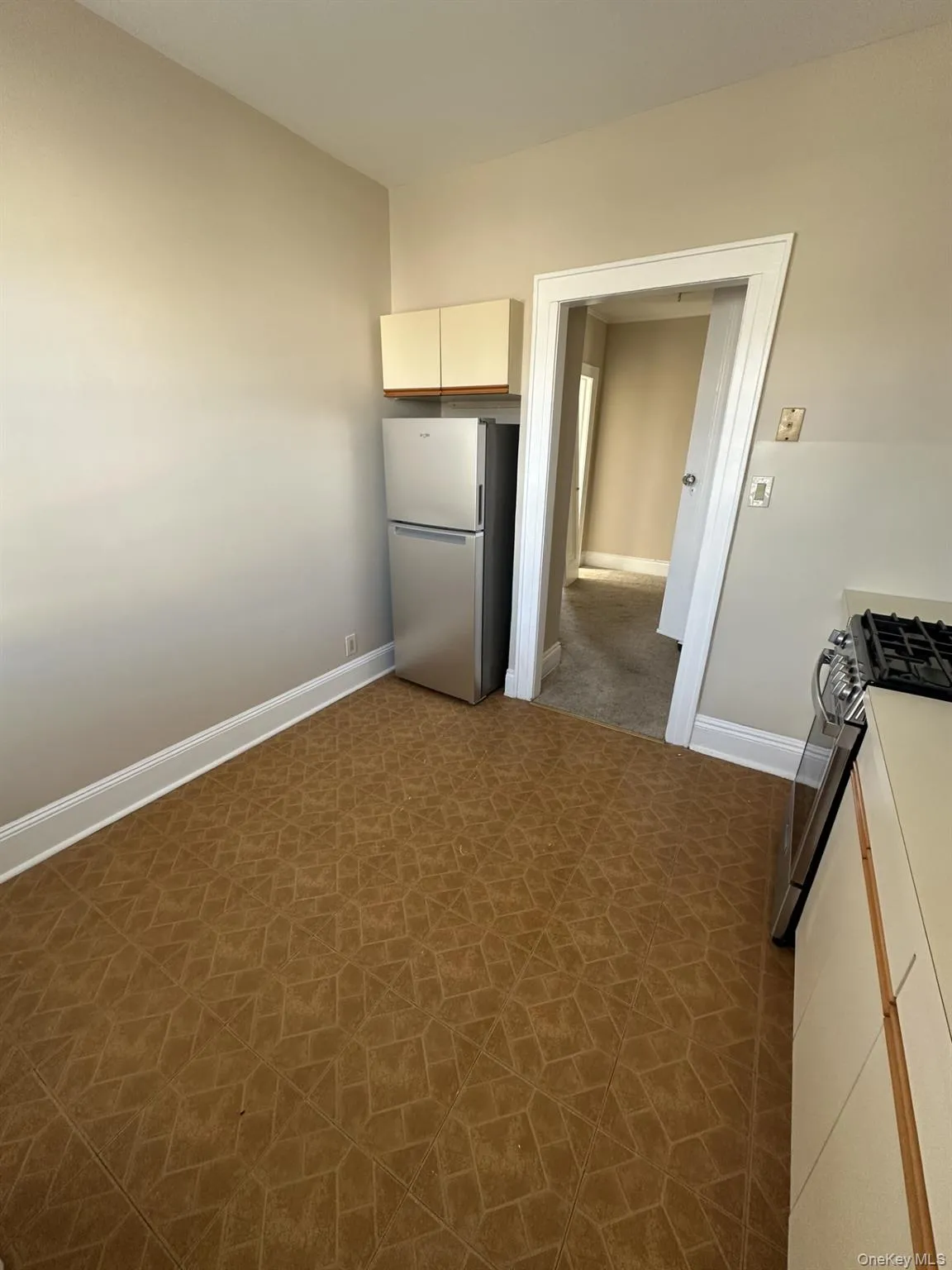 Kitchen featuring baseboards and stainless steel appliances Kitchen featuring baseboards and stainless steel appliances